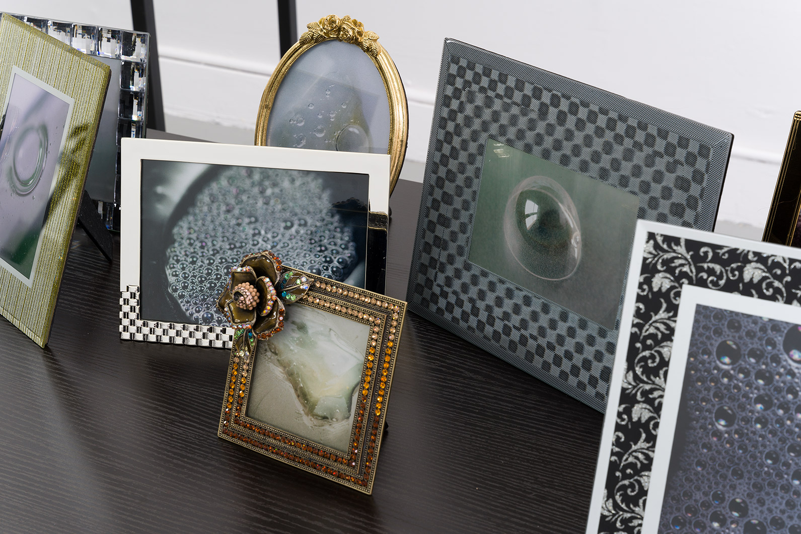 Bulles [detail], 2024, prints, frames, table, 36 x 55 x 24 in. (91.4 x 139.7 x 61 cm.)