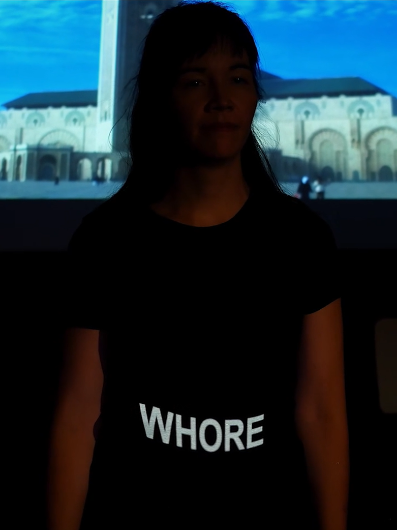 Lisa with the word "whore" projected onto her shirt