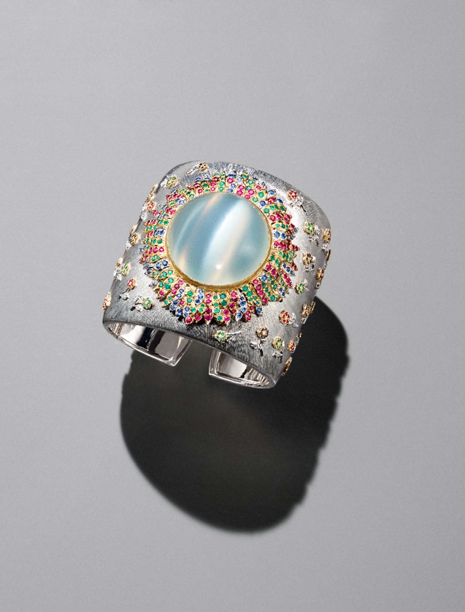 KMA stylist Sara Wacksman designs set for a photo of bright opal and diamond ring on a gray background for Bergdorf Goodman