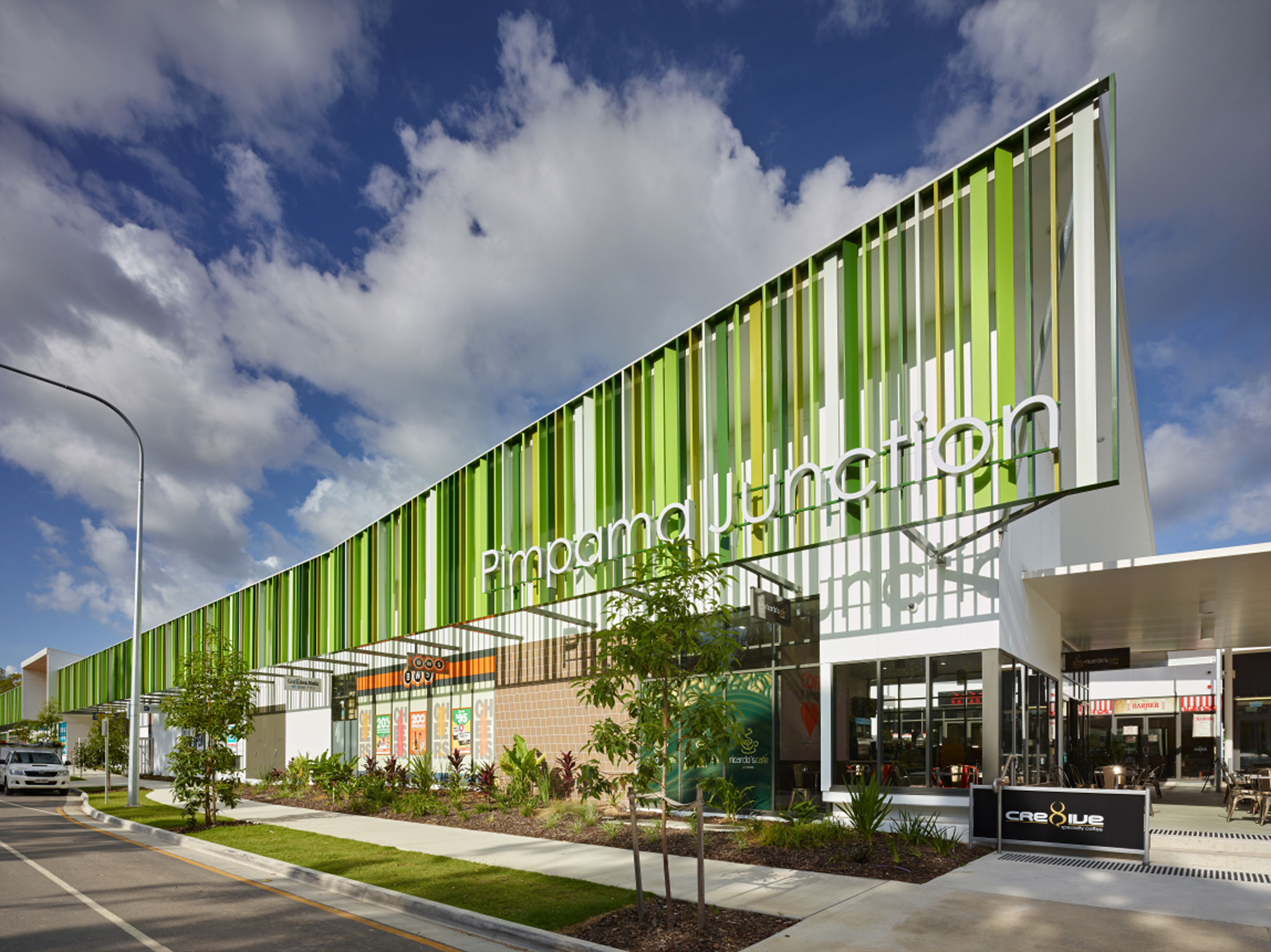 A building with alternating green and white stripes on its front façade.