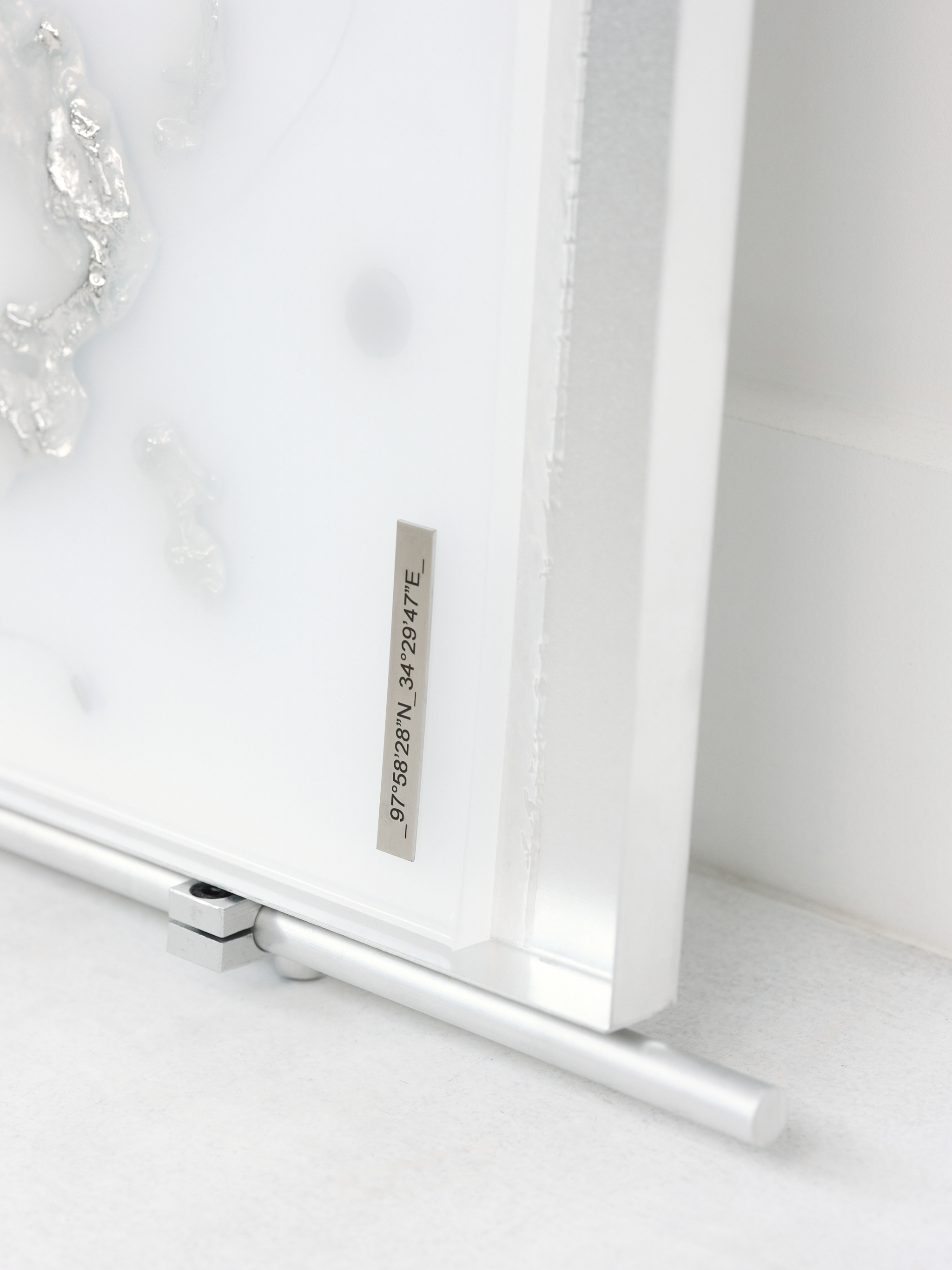 Imperma_97°58’28”N_34°29’47”E_  2025,  [61cm x 66cm x 10cm]  Art-O-Rama invited by Xxijra Hii Gallery, Marseille  Eco resin, aluminium, pewter, labels, found metal components and drain chain. 