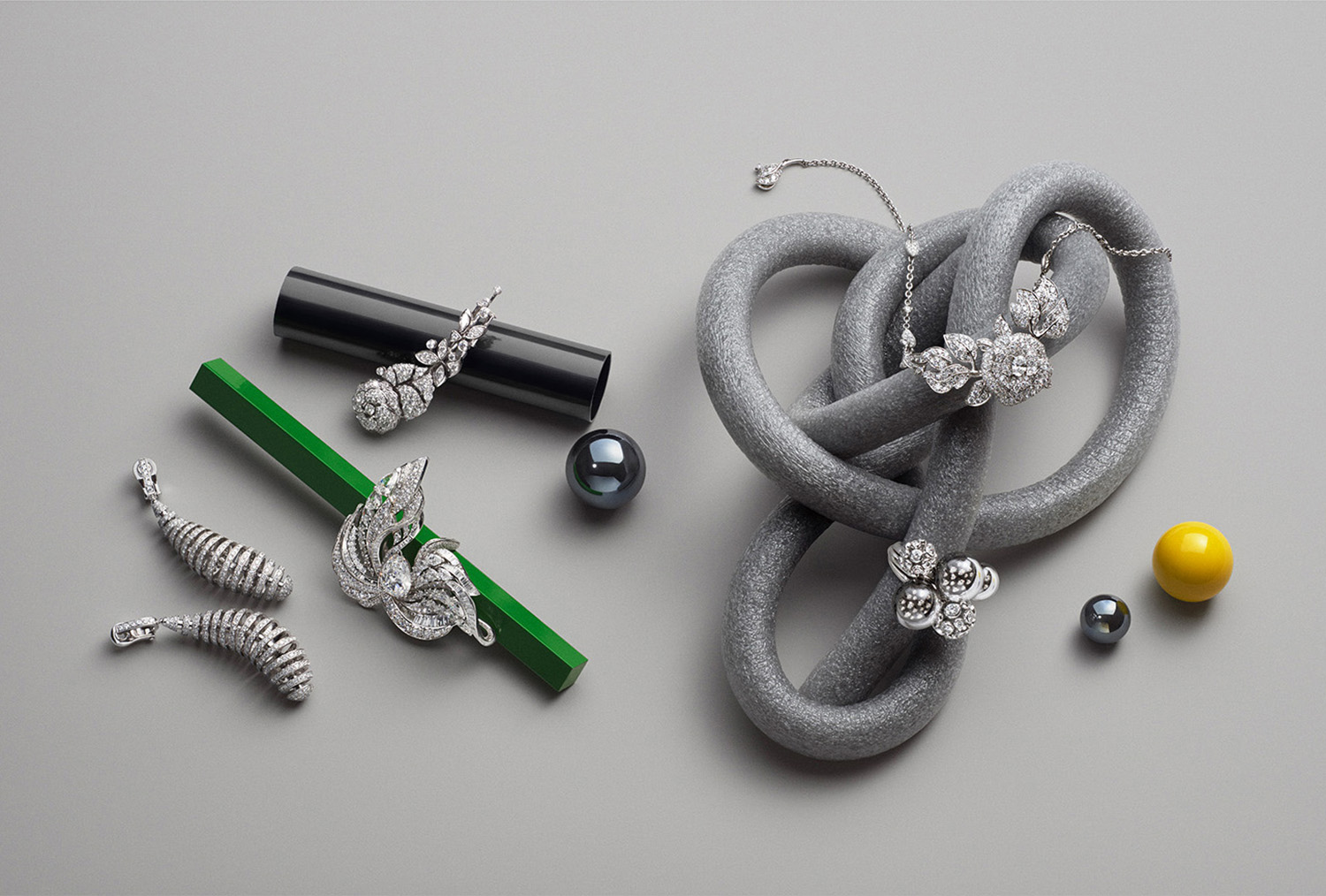 KMA stylist Sara Wacksman designs set for photo of diamond jewelry scattered across a gray background for Vogue Hong Kong