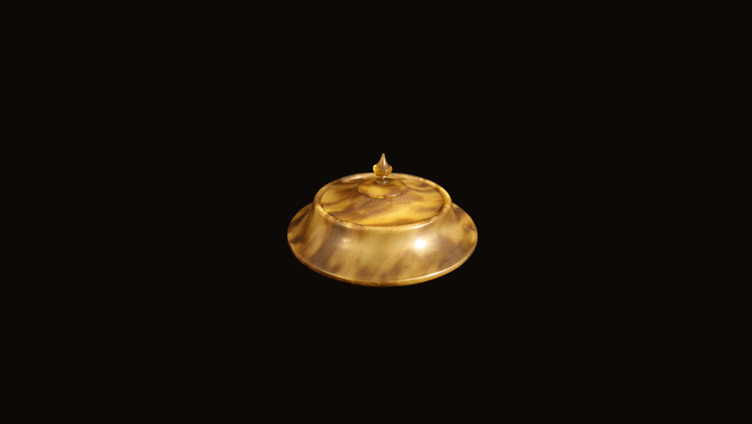 Bakelite dish on black cloth, performance, 2018