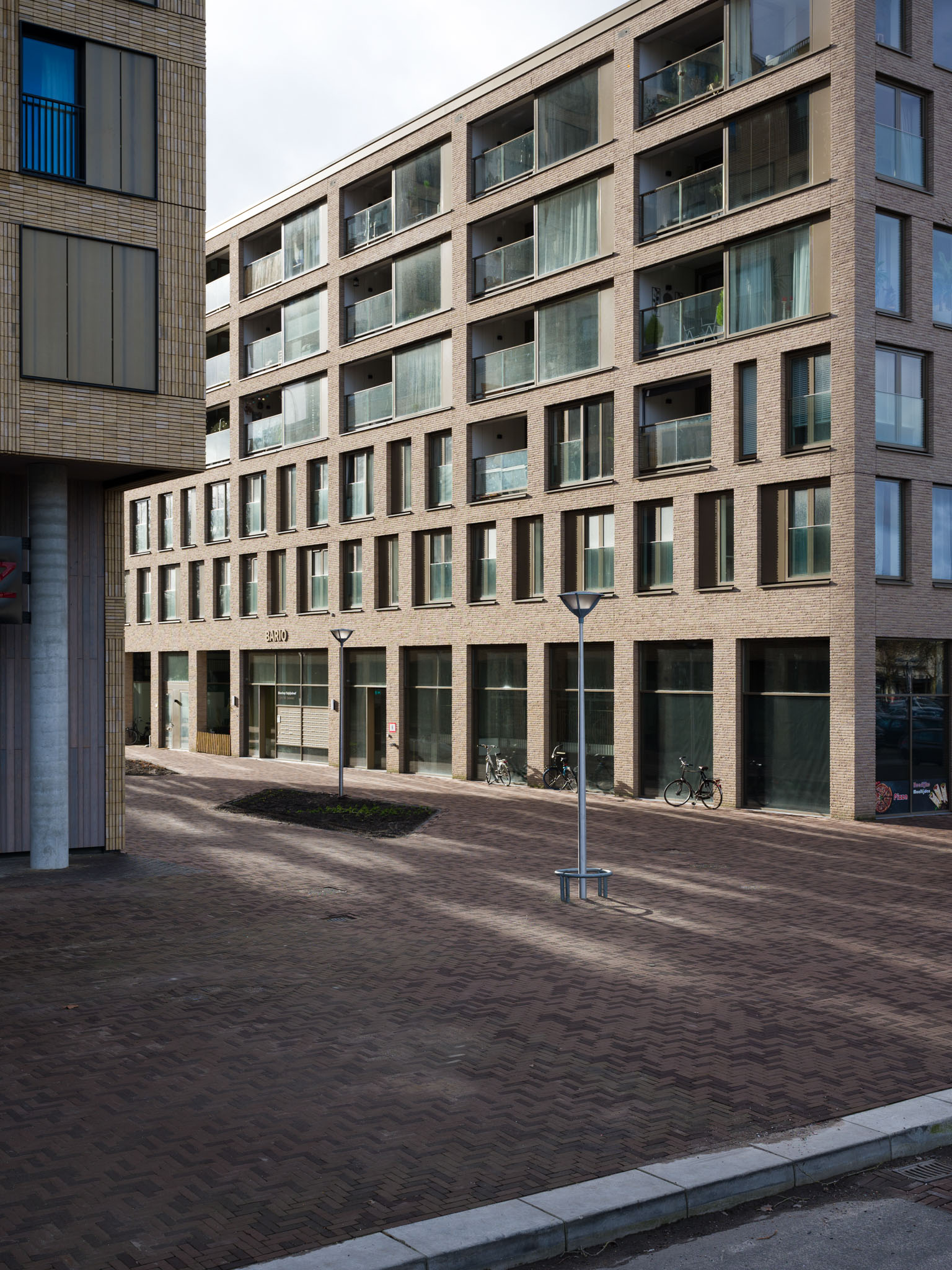 The corner from The Cube by Team V Architecture on the left and on the right Bario by Paul de Ruiter Architects.