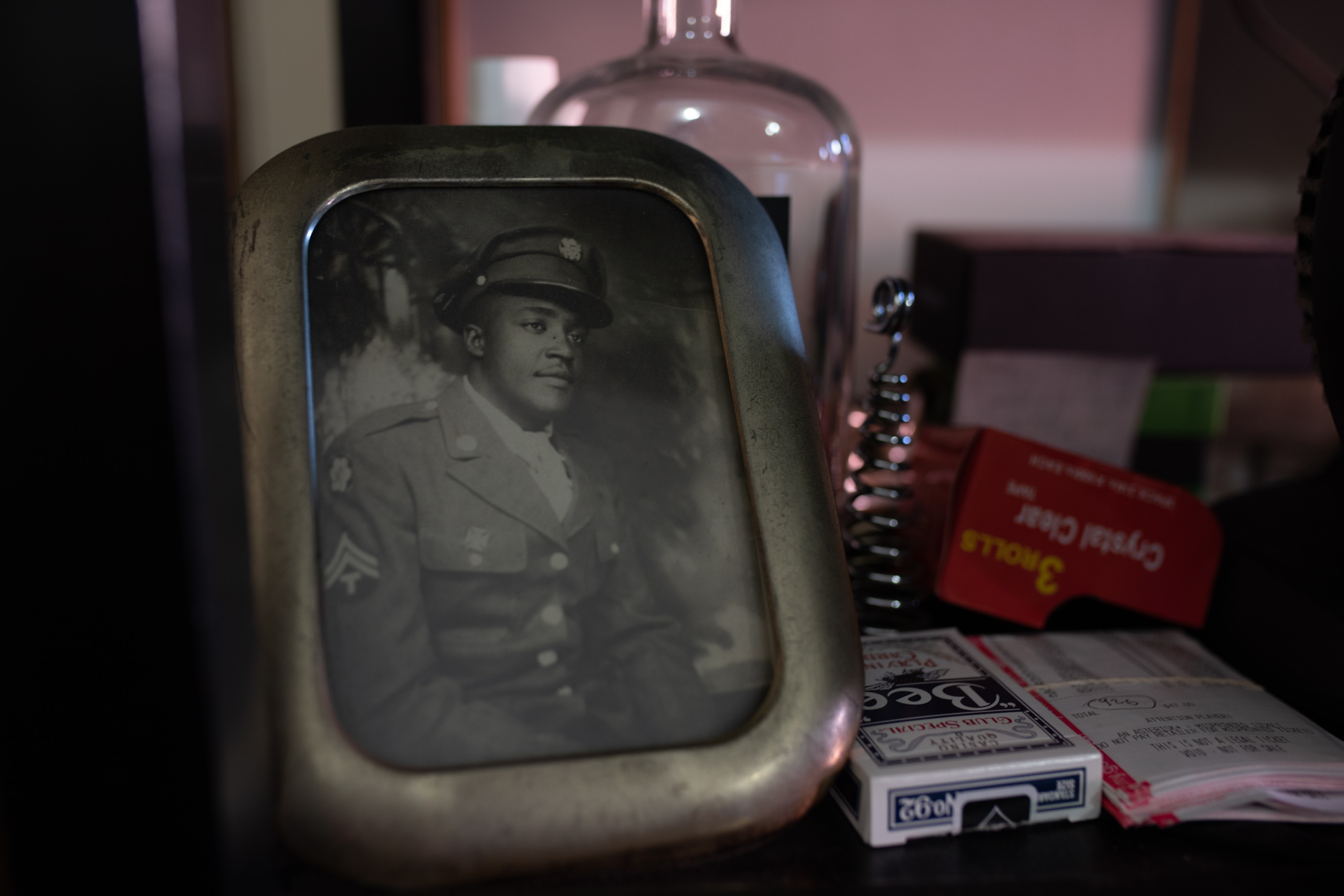 The mementos we keep in our small New York City apartments reveal our values. Gee uses his space to display memorabilia and family photos including this photograph of his stepfather, John Henry Broome during his World War II service.