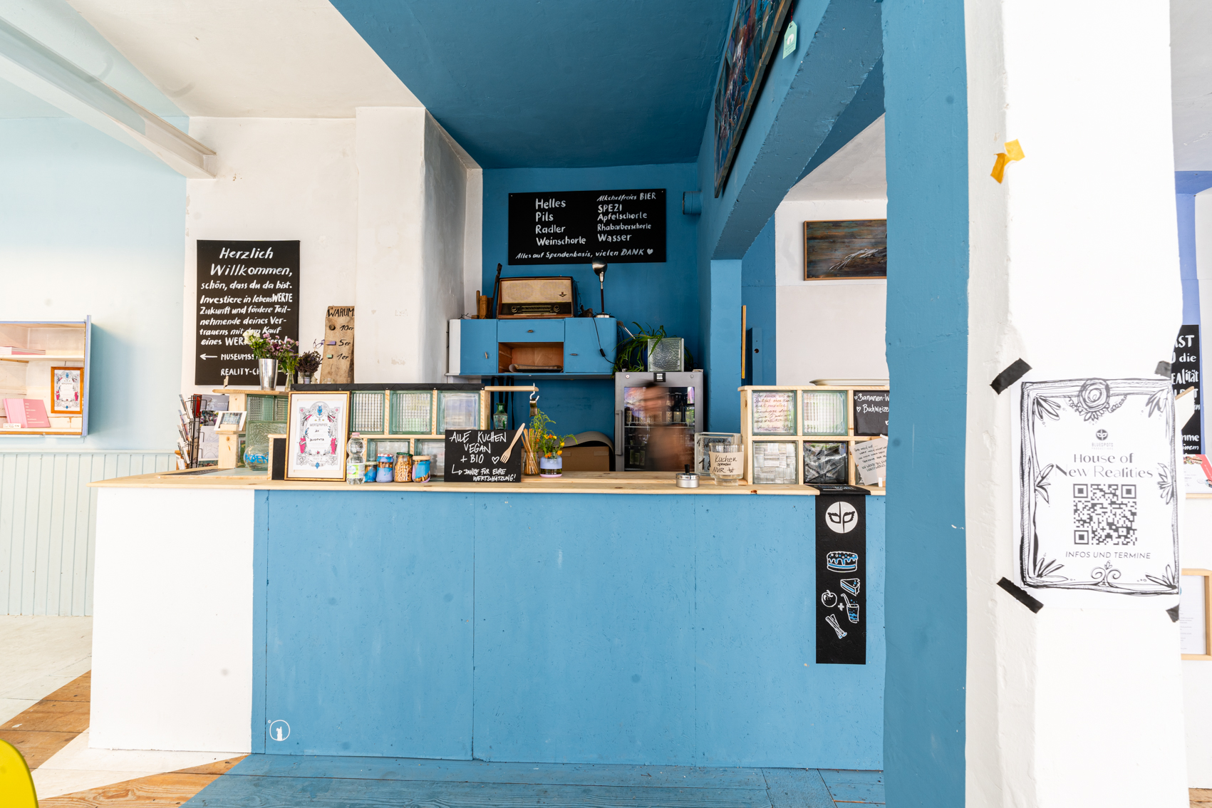 Bild 2 zu Cafe Eder: Ansicht der Bar. Die Bar ist gr&ouml;&szlig;tenteils Blau. Die Anrichte ist mit kleinen quadratischen Glaselementen erh&ouml;ht. 