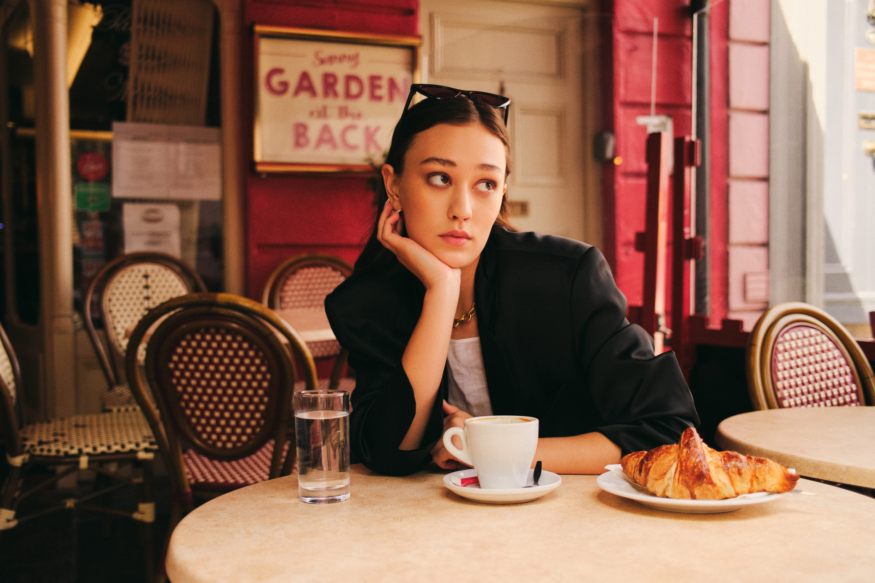 Luxurious fashion editorial photoshoot in Dublin, Ireland, featuring a stunning model in vintage clothes. Photographed in the city's trendy French cafes, this photography showcases the elegance of high-end fashion and the charm of vintage clothing. Captured by a skilled photographer, this editorial is sure to impress.