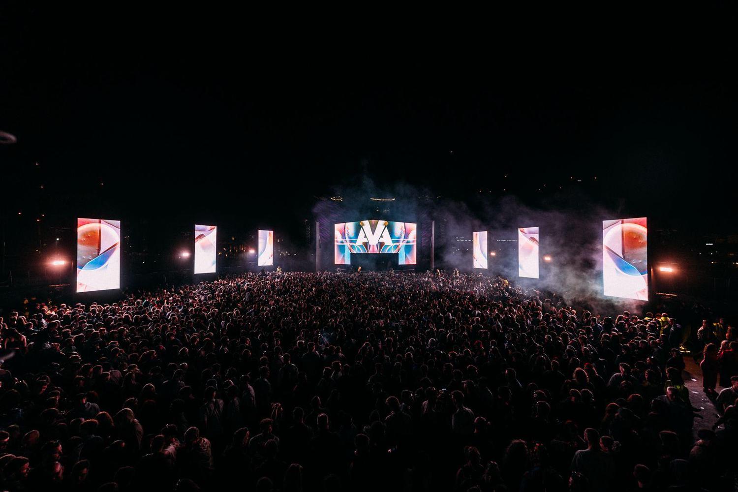 Massive crowd at AVA Festival 2025 main stage night show with large LED screens and visuals