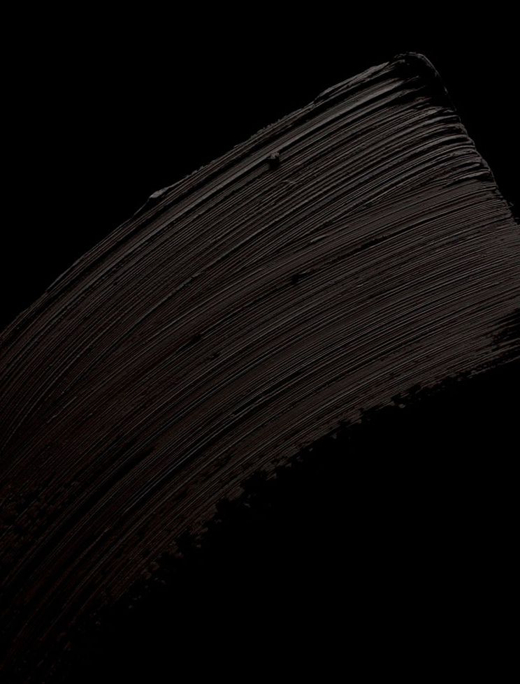 KMA stylist Rachel Haas designs set for texture photo of smeared thick black mascara on black background for Gucci