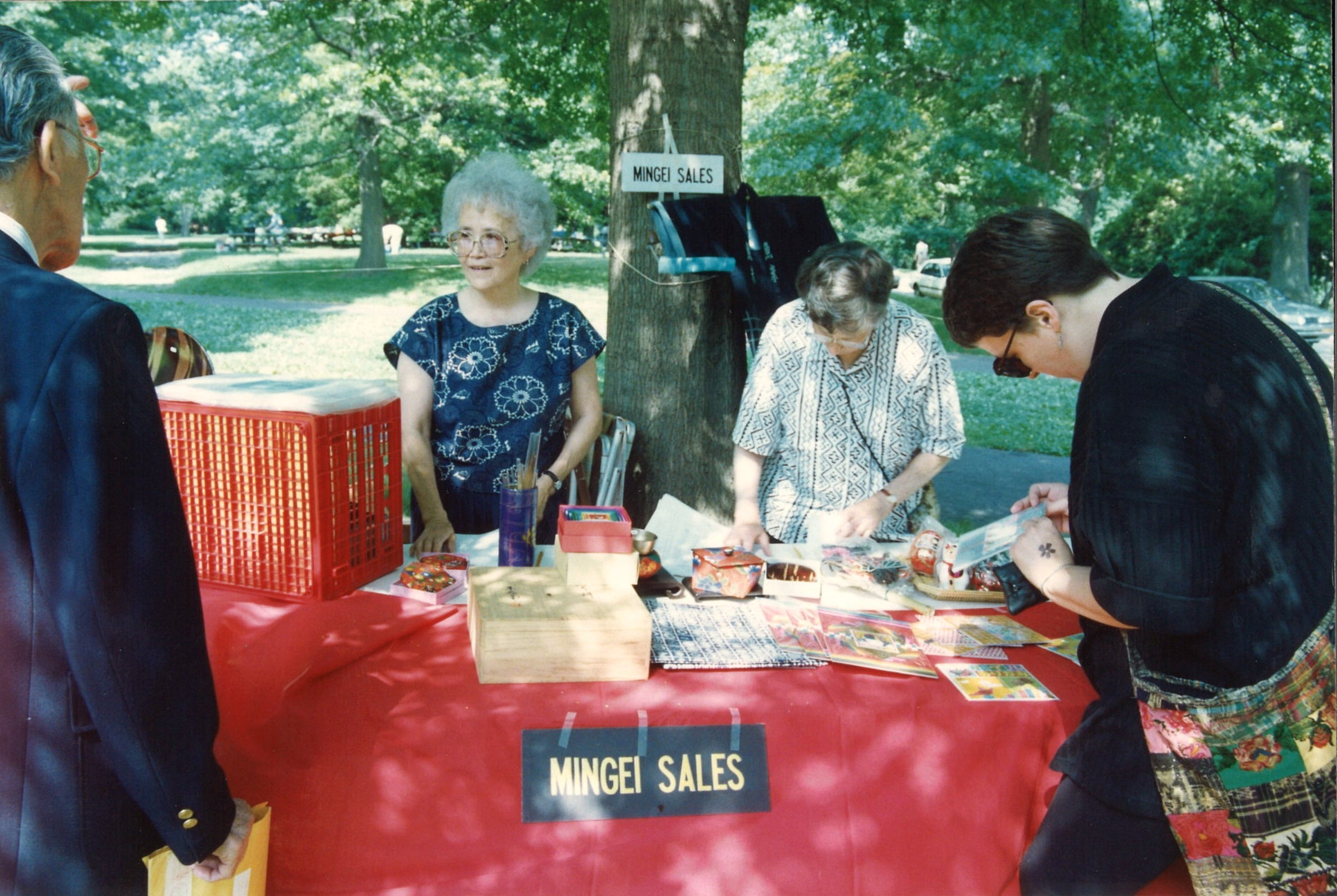 Shigeko Kawano working a mingei, or folk arts, booth at a festival, 1999