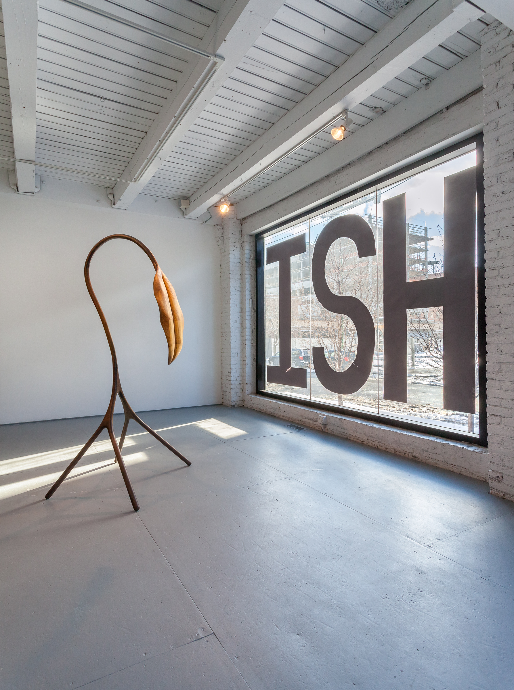 5/5 — SELFISH.  Site-specific installation created for the exhibition Hiding in Plain Sight, curated by George William Price at the Chicago Artist Coalition; hand-cut paper, packing tape; text on floor "SELF" measure 144" x 48" each, text on window "ISH" 96" x 48" each) 2017.