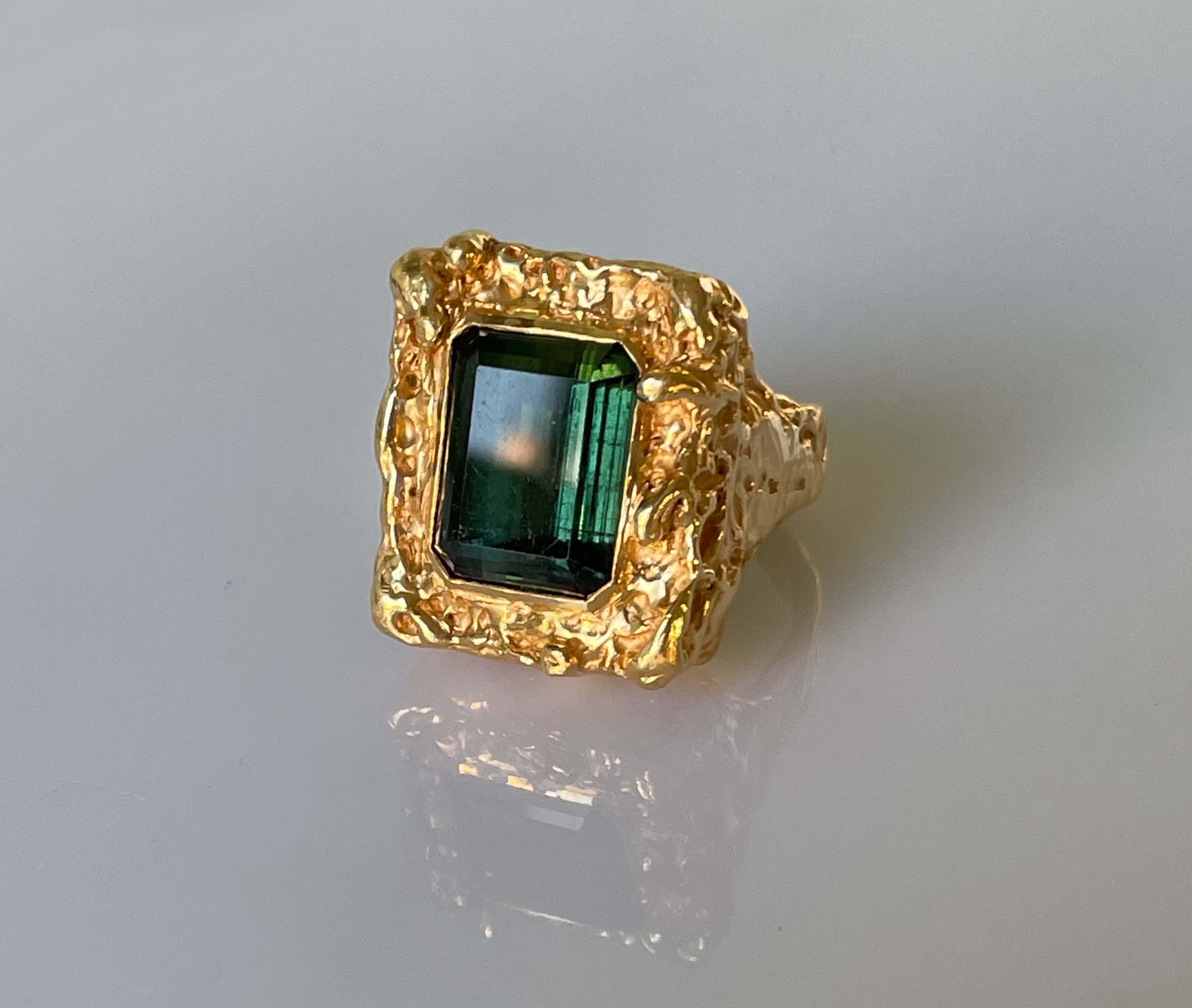 DAMIEN'S ERGOT. 22CT GOLD MELTED AROUND A 7CT TOURMALINE
