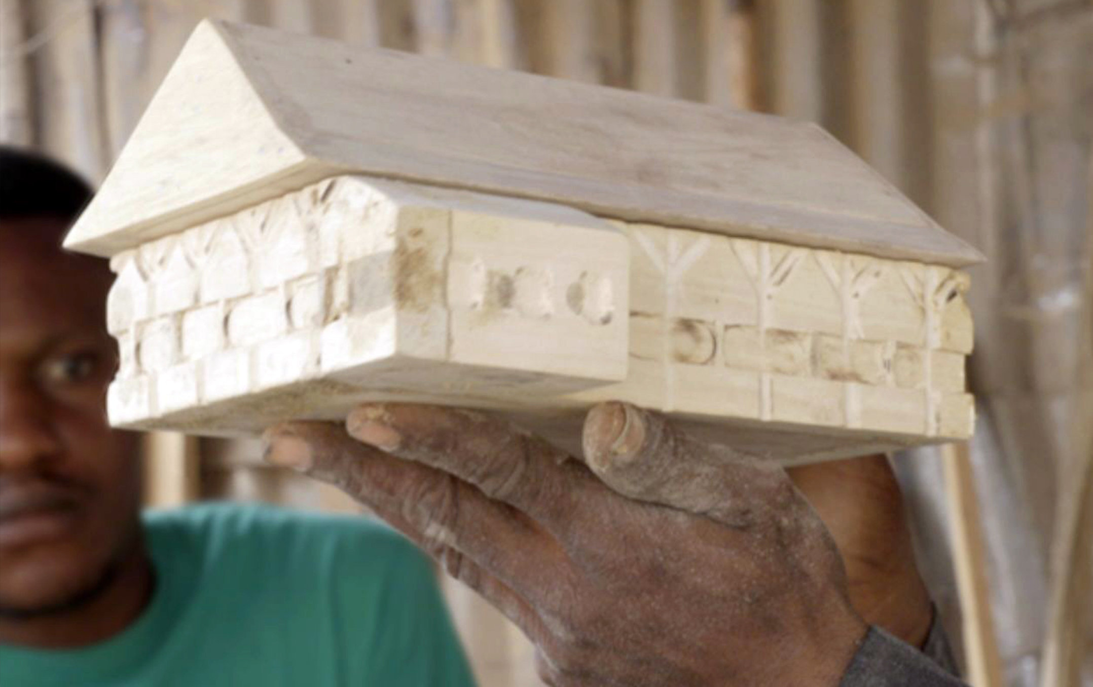 Still from film with scale replica of Colonial Bungalow