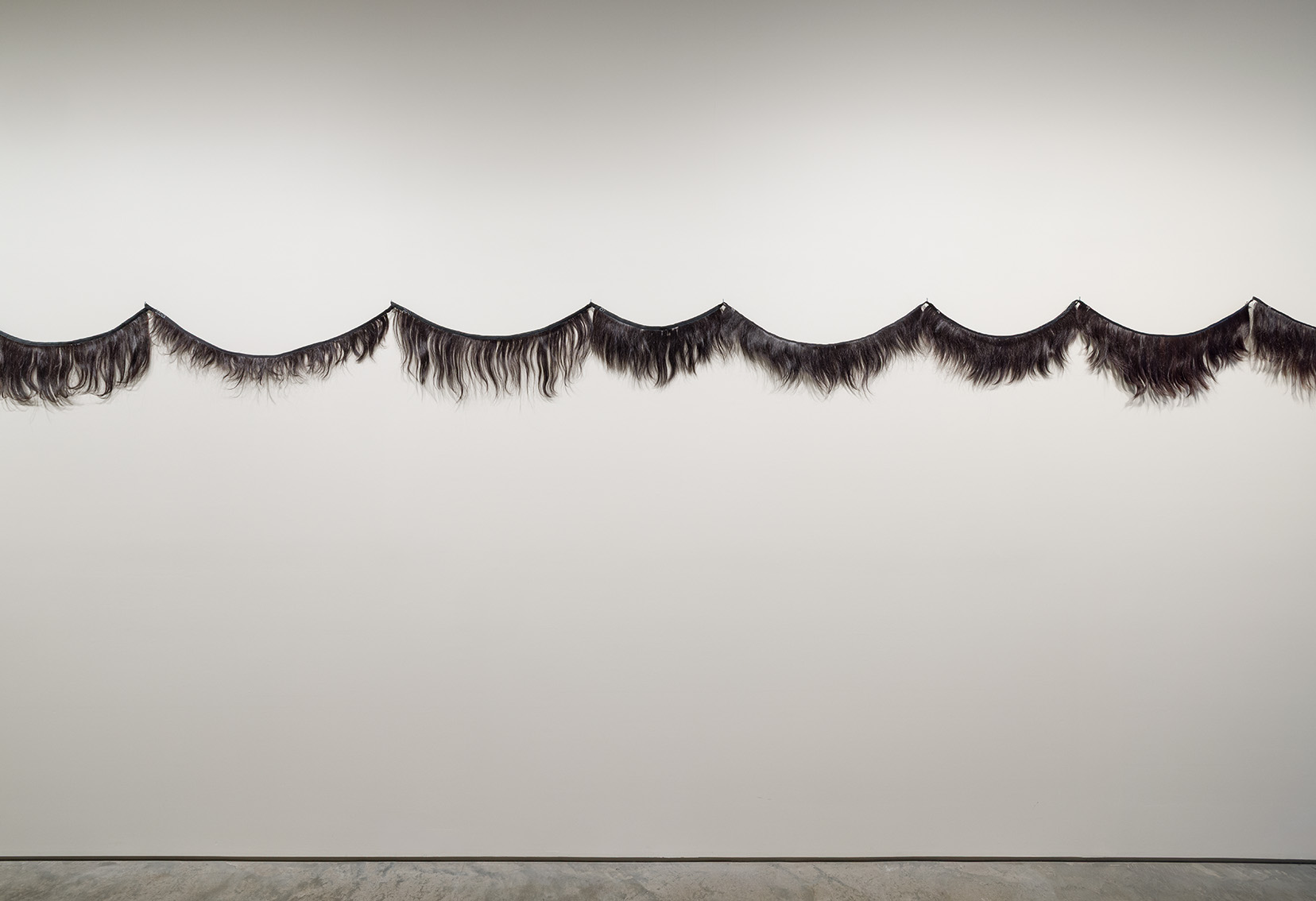 Germaine Koh, Fête, 1997–ongoing . Artist’s hair, ribbon, binding, 21 x 430 inches. Photo by Etienne Frossard.