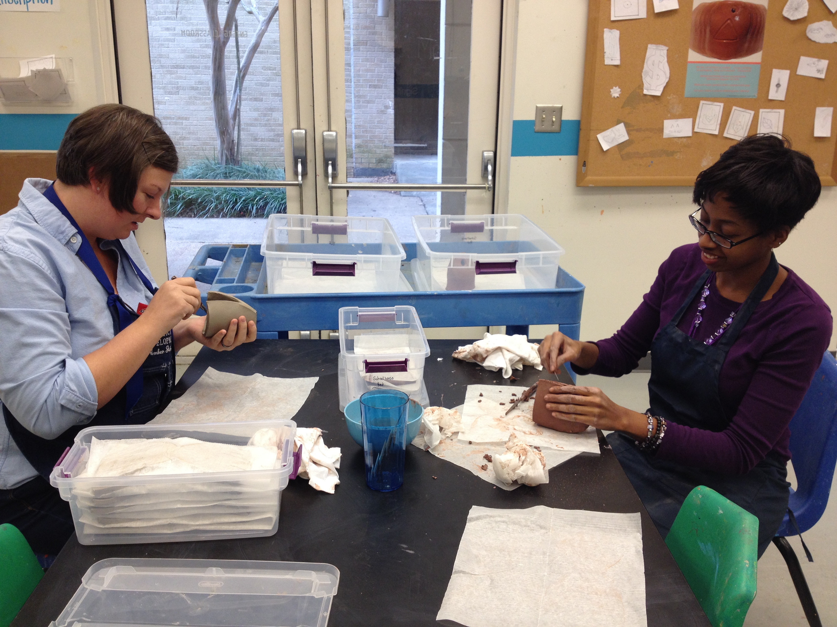 artists Amber Johnson and Kira Cummings chatting and shaping