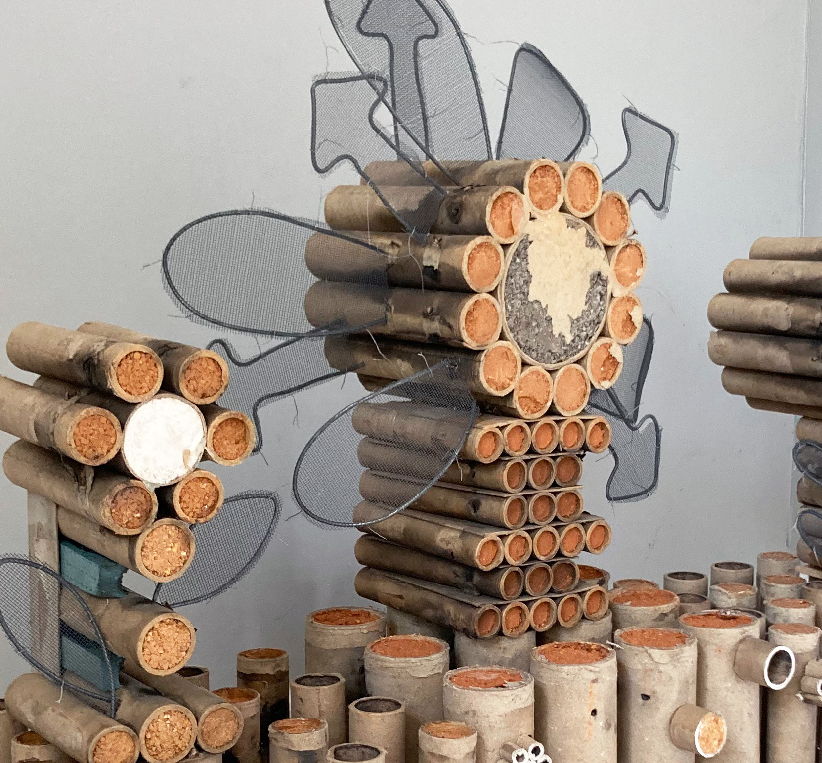 Earth Tower, 2023, Found firework refuse, wire, aluminum mesh, wood, 32" x 10" x 28" (detail)