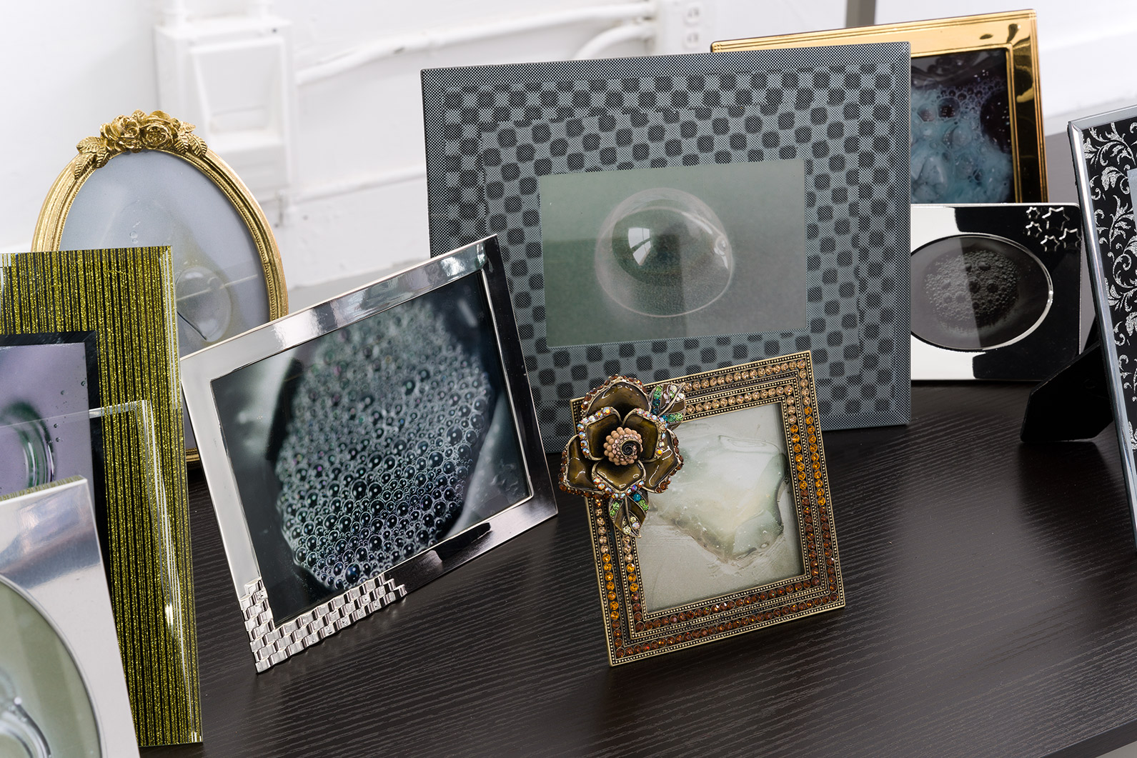 Bulles [detail], 2024, prints, frames, table, 36 x 55 x 24 in. (91.4 x 139.7 x 61 cm.)