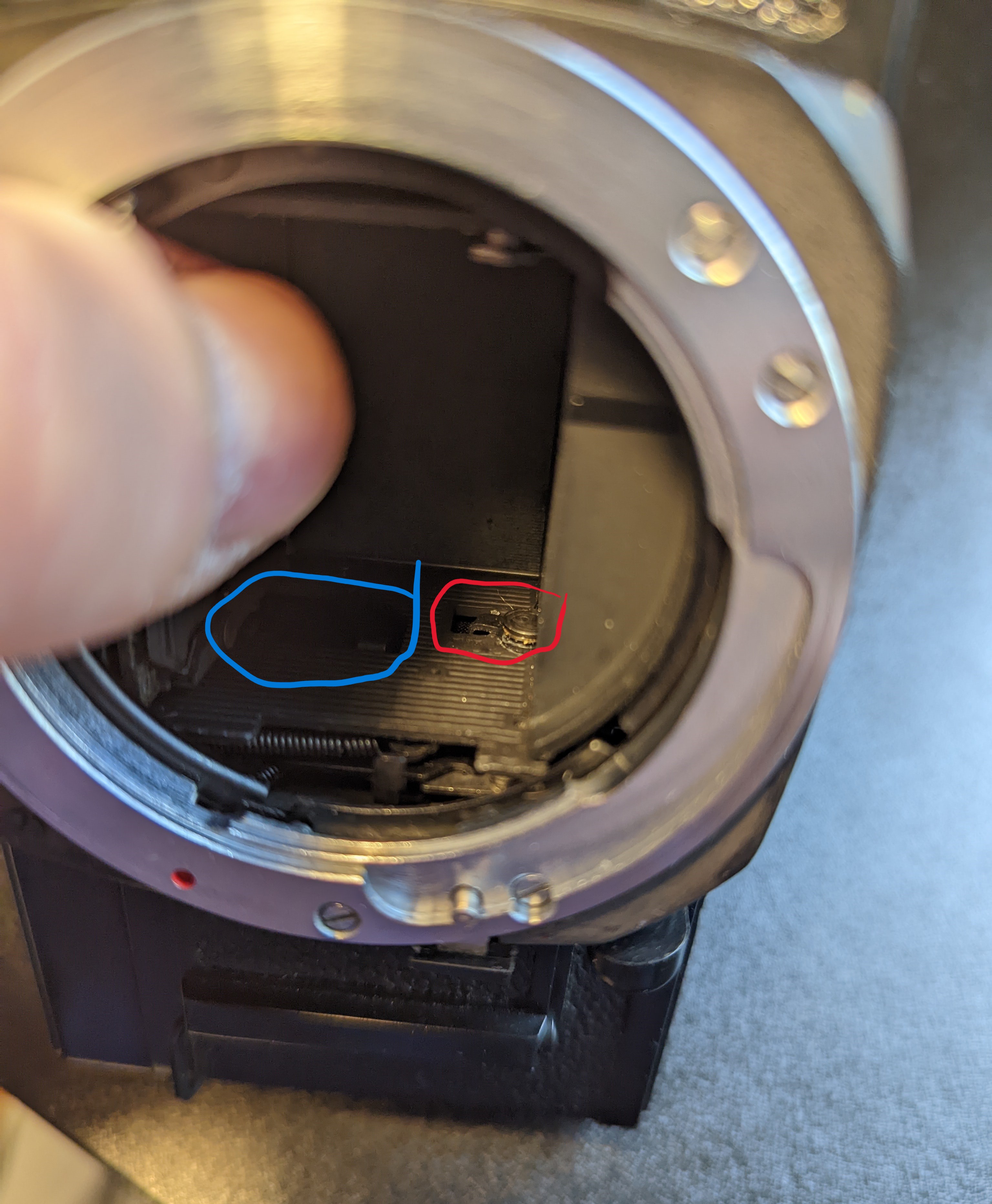 1. Red circle shows the mechanism that connects to the shutter mechanisms on the bottom. This one initiates the mechanism shown in the blue circle which is responsible for raising an lowering the mirror.