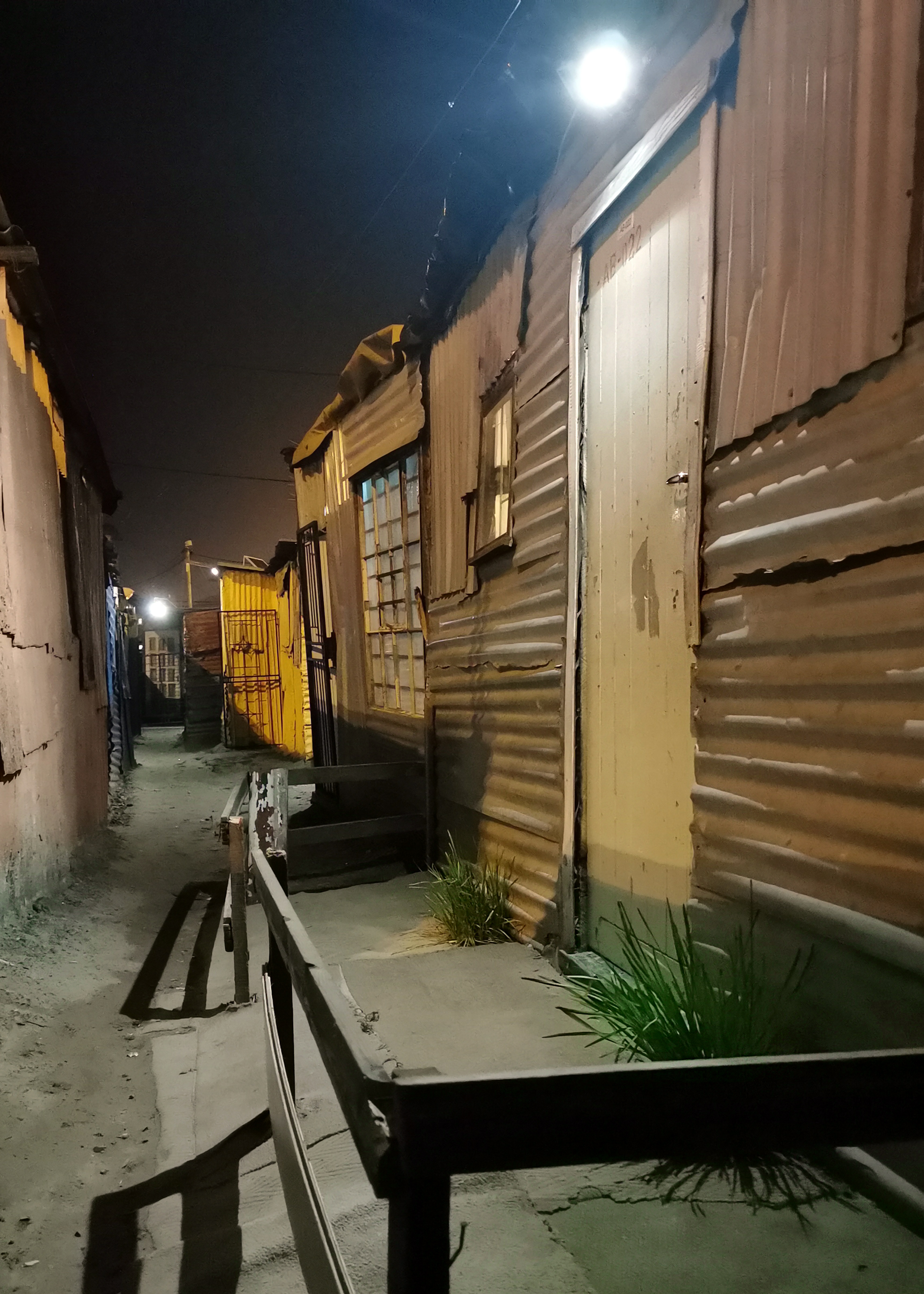 The result of wall-mounted public lighting installed above the front door of each home. 