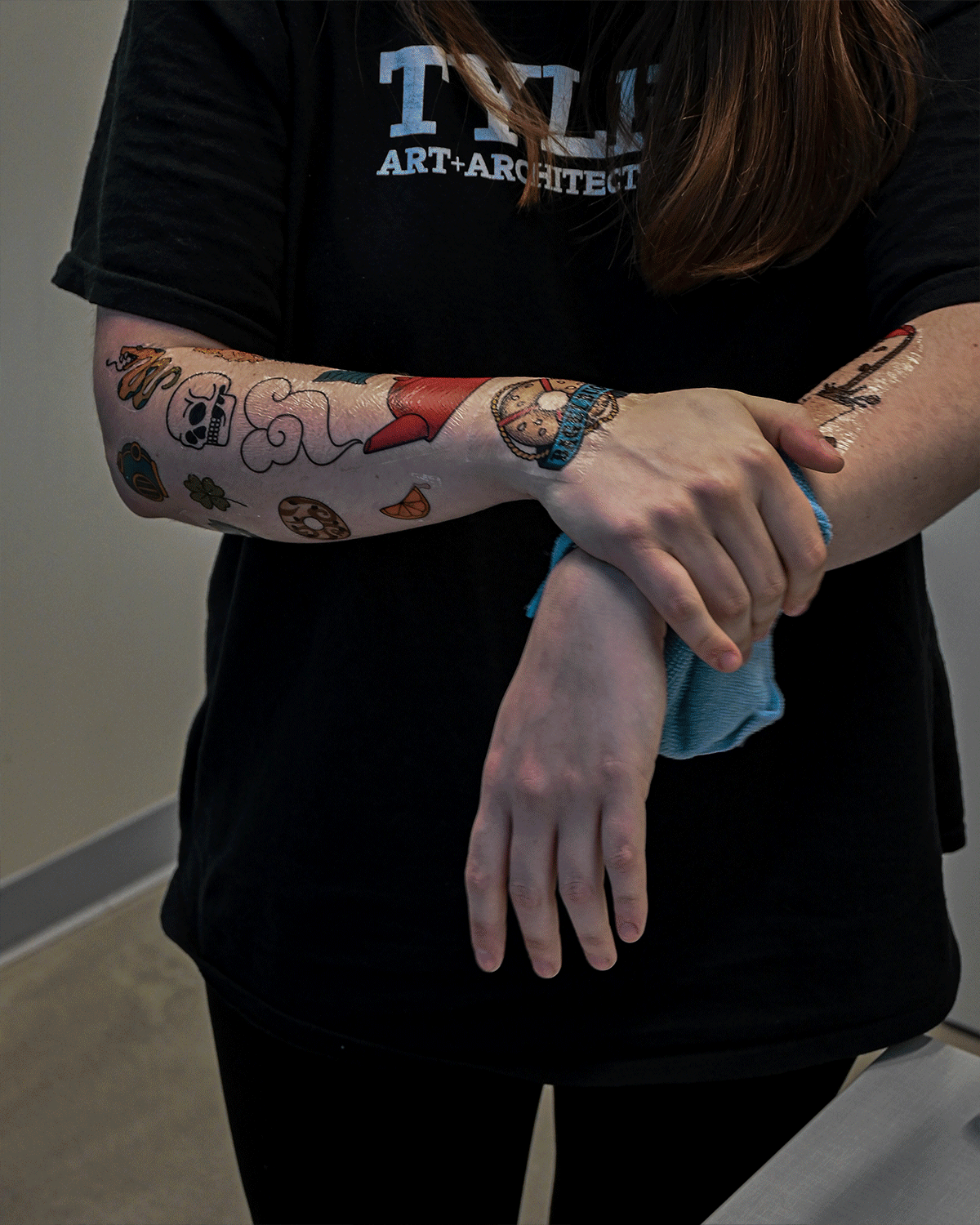Gif showing two models wearing temporary tattoos with designs from the brand.