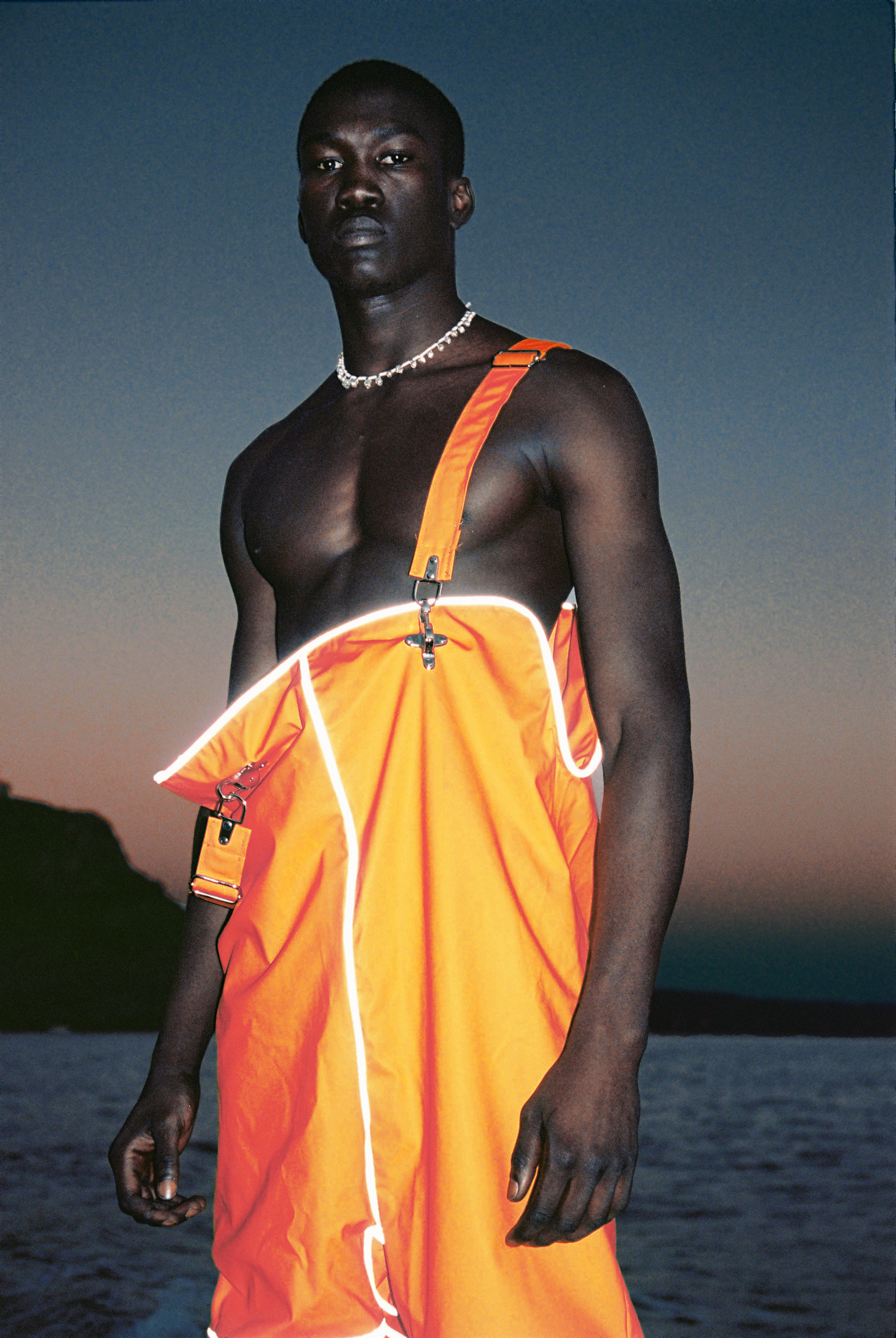 Diop is wearing dungarees by ANNA SÓLVEIG & a necklace from EMBIRIKOS