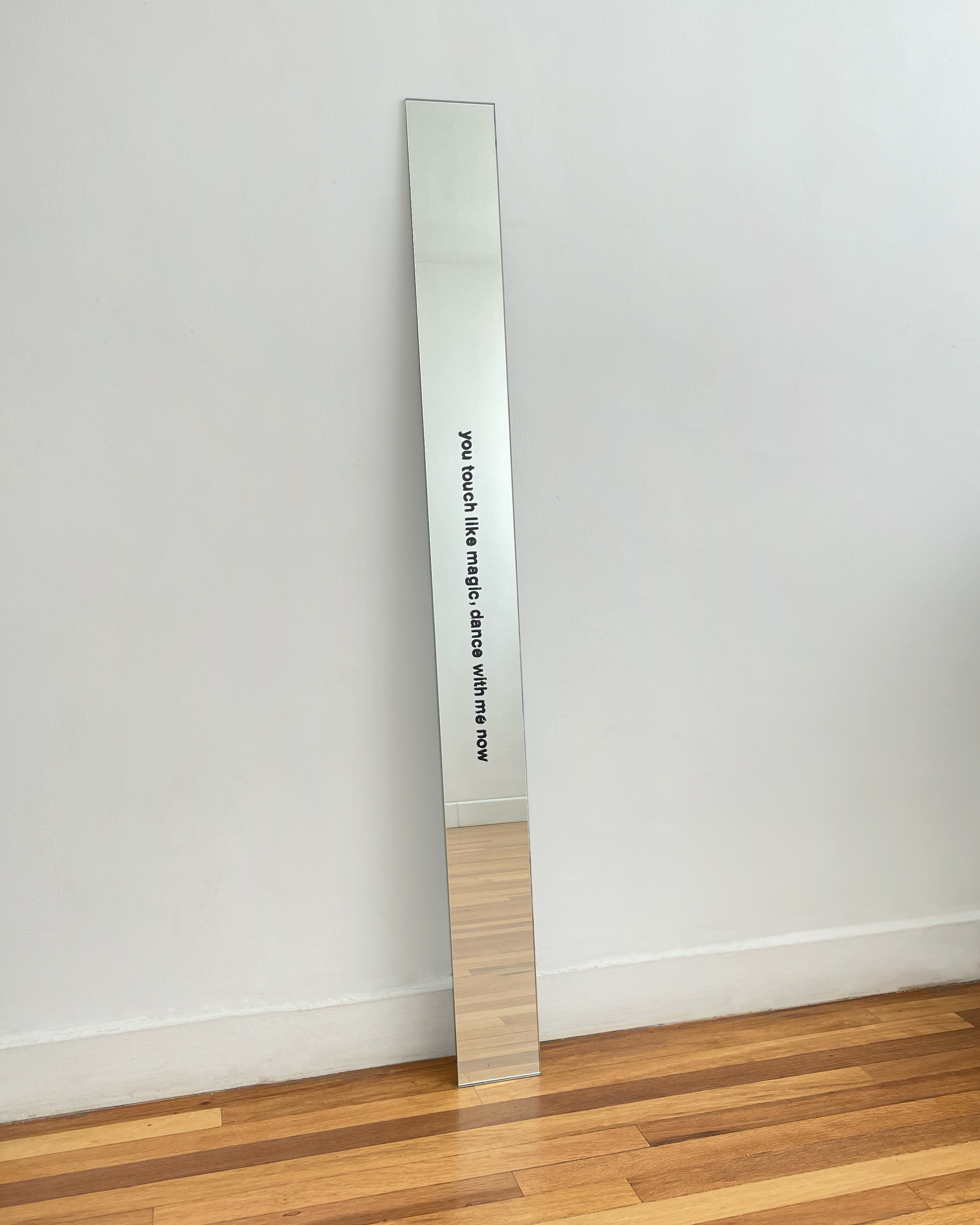 You touch like magic, dance with me now,&nbsp;2023.&nbsp; Letraset on mirror glass. 15 × 140 cm