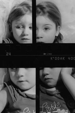 Black and white 35mm contact sheet capturing the raw expressions of a three-year-old child. A study in innocence and emotion through film photography.