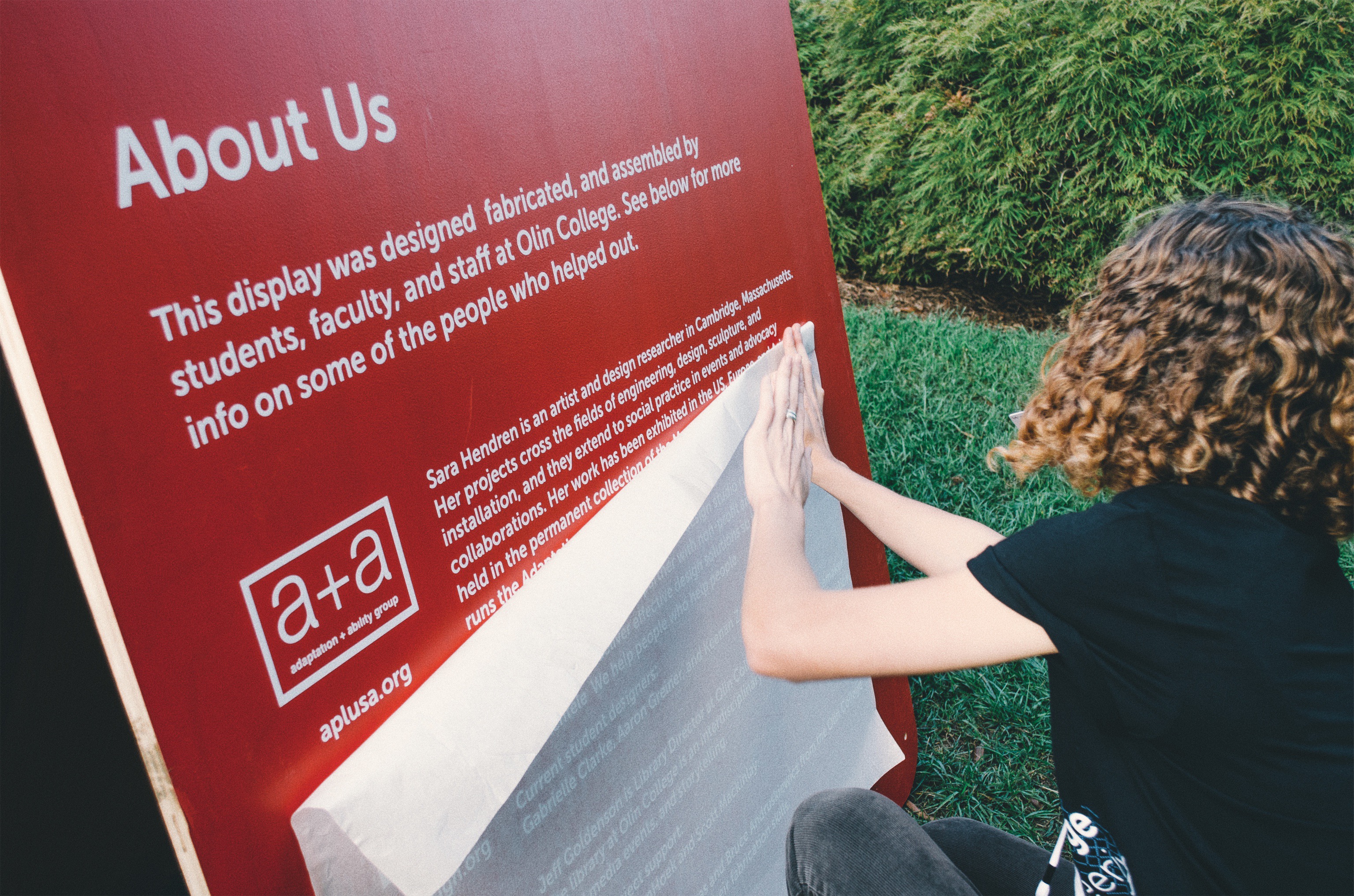 Transferring vinyl lettering to a sandwich board that sat outside the booth.