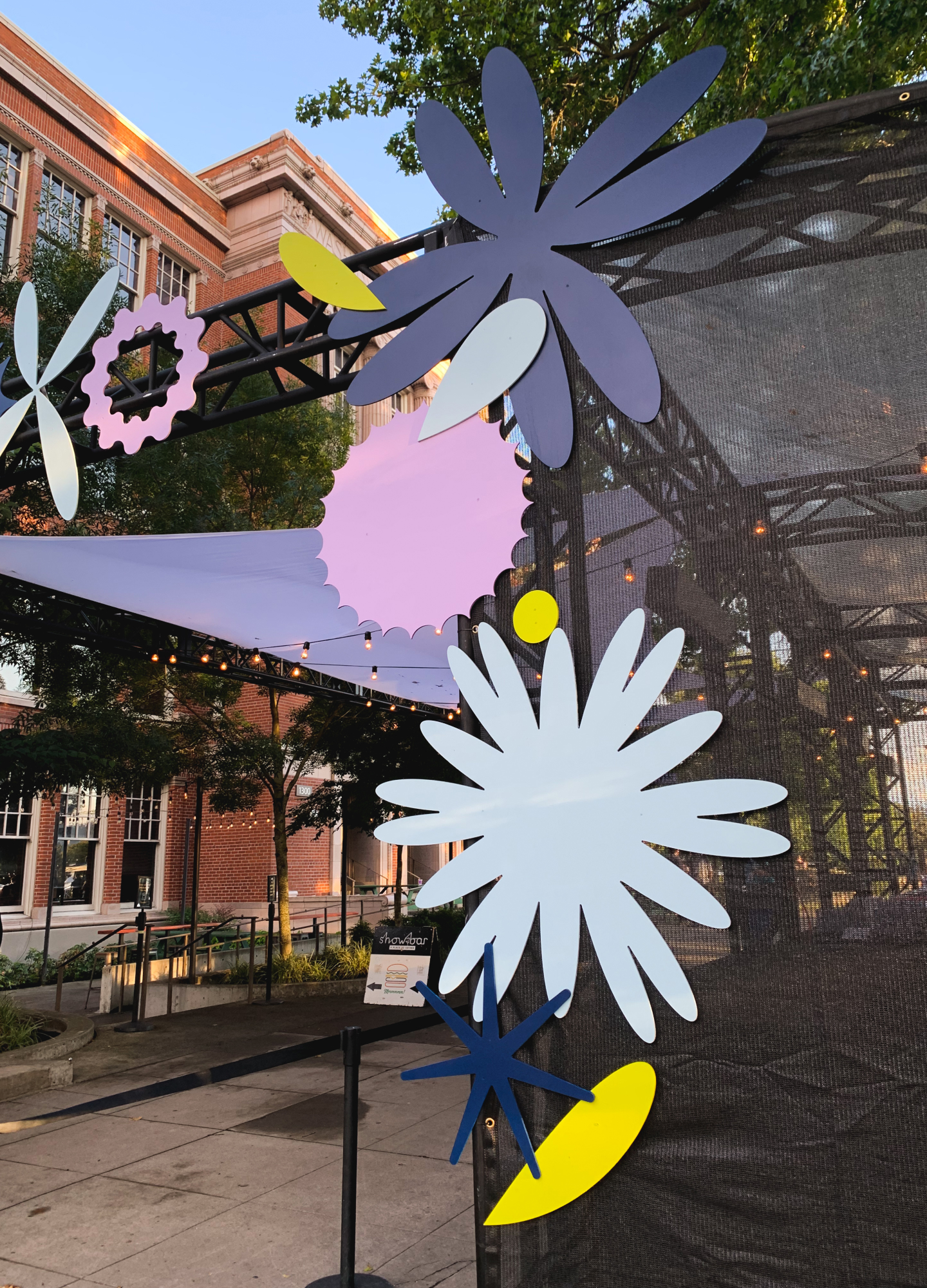 A medium-close view of some of the flower cutouts on one side of the entrance. Bright geometric flower shapes in radial patterns.