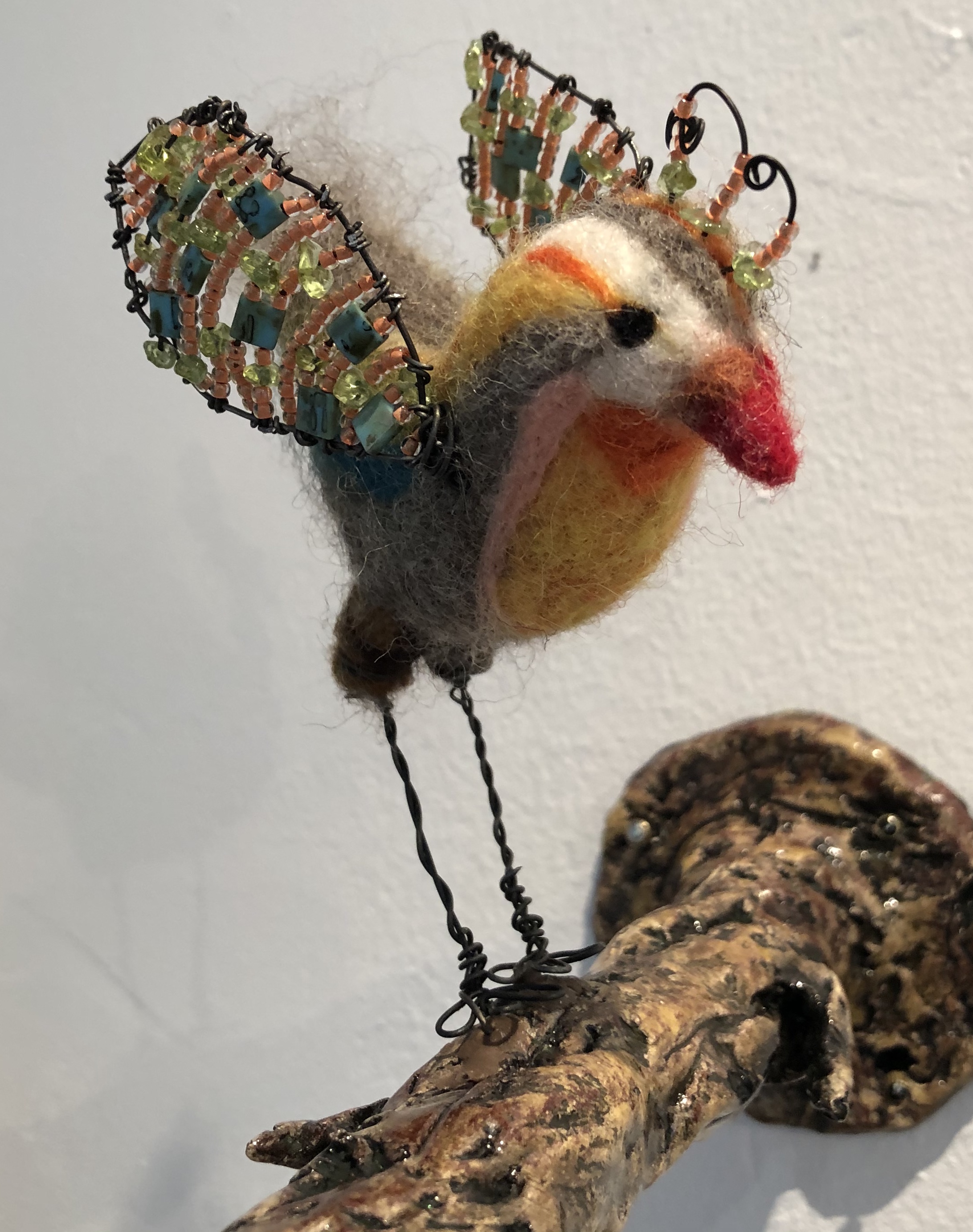 Untitled (bird on branch) → ceramic, felted wool, steel wire, glass and gem beads
