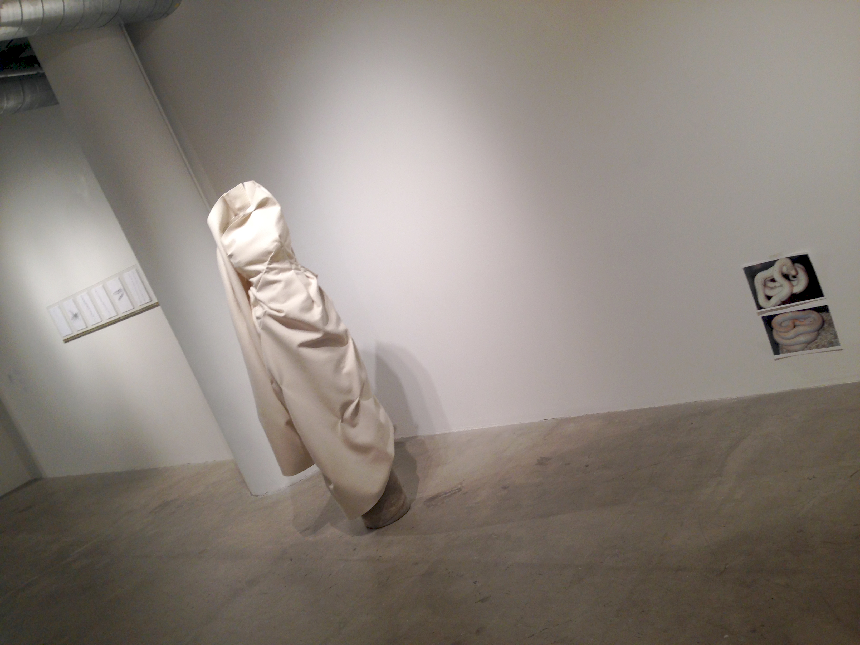 6/11 – JOHN AND MARY.Undyed, fire-resistant wool felt, brass, buttons, wire, sonotube, concrete. 140 cm x 320 cm x 30 cm variable, 2013.