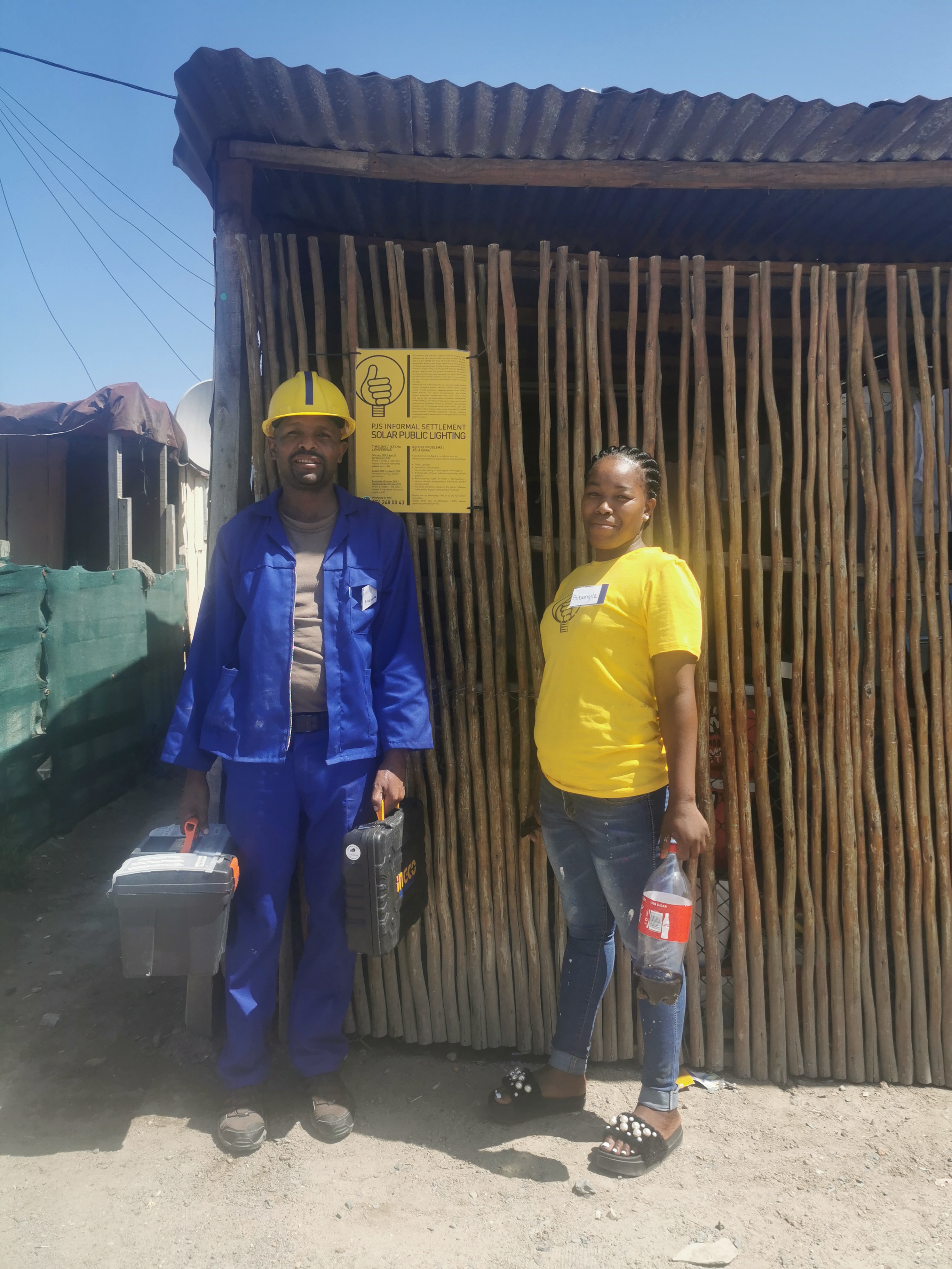 The local team trained to install the wall-mounted solar lights in their community