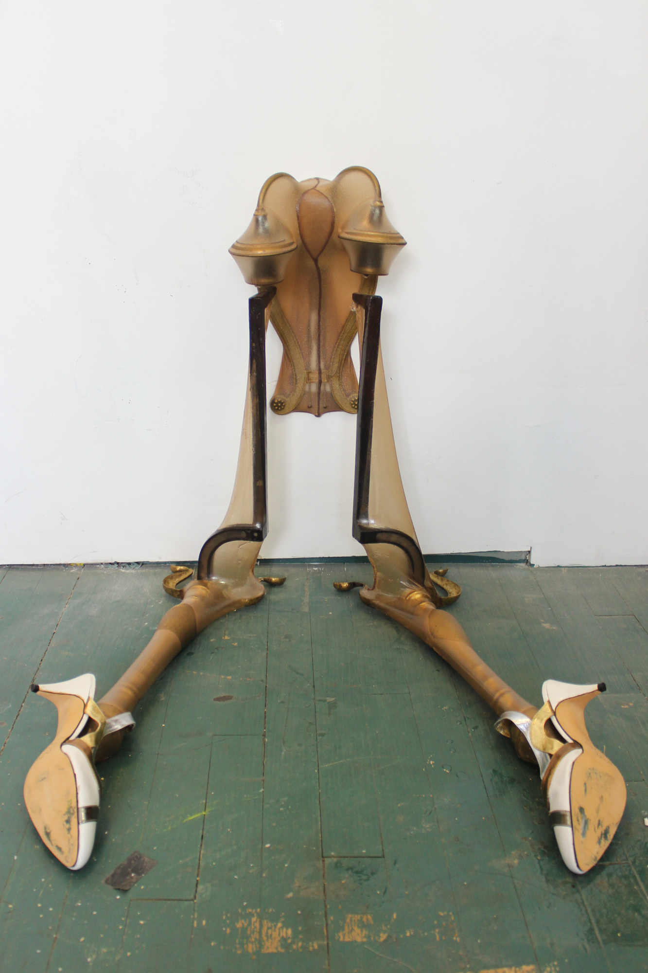 Bunny loses an eyelash, 2024, Sconce, fireplace andirons, stockings, resin, shoes