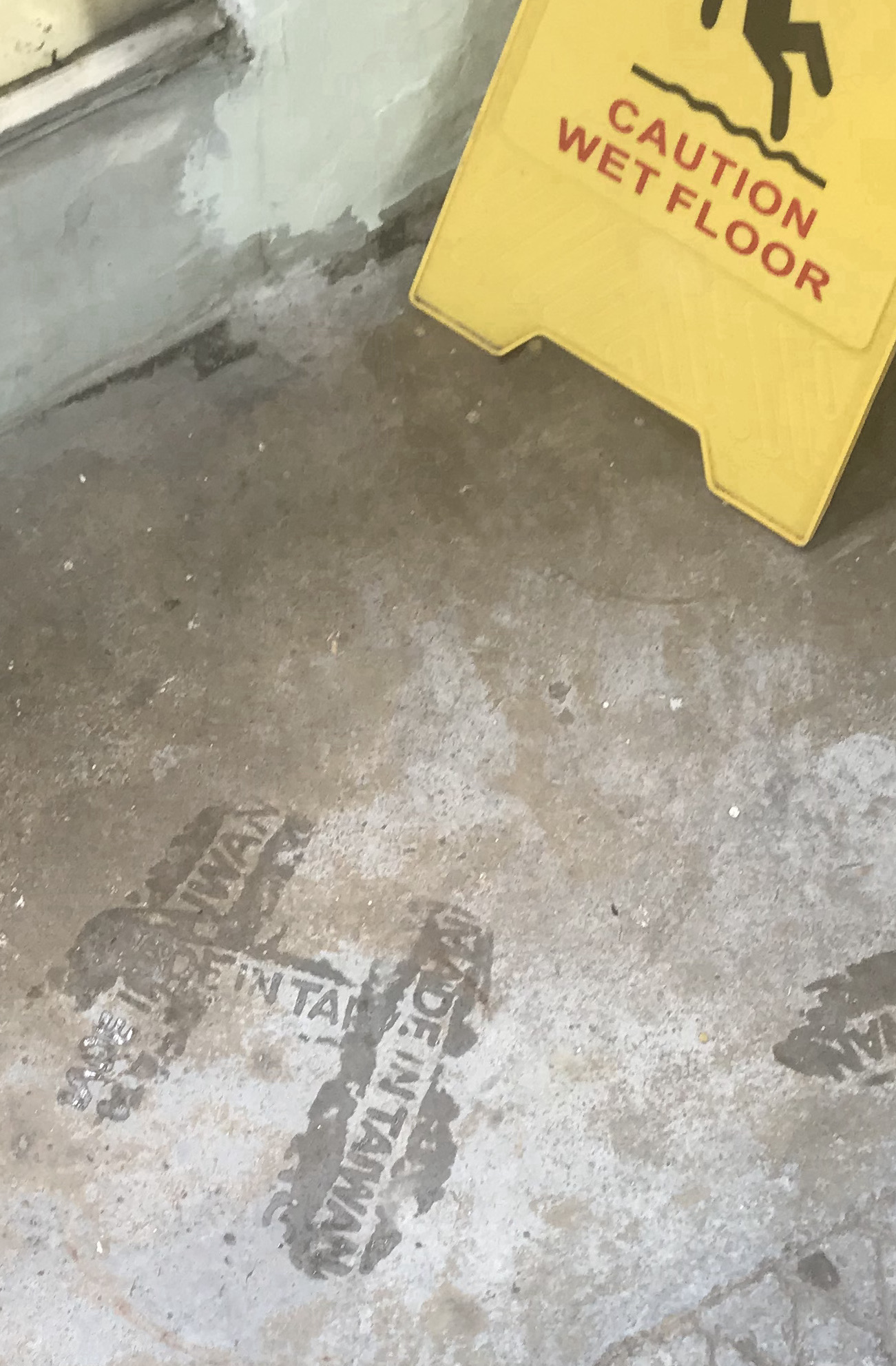 Sandals on wet floor. AVA building of HKBU, Hong Kong. September 2019