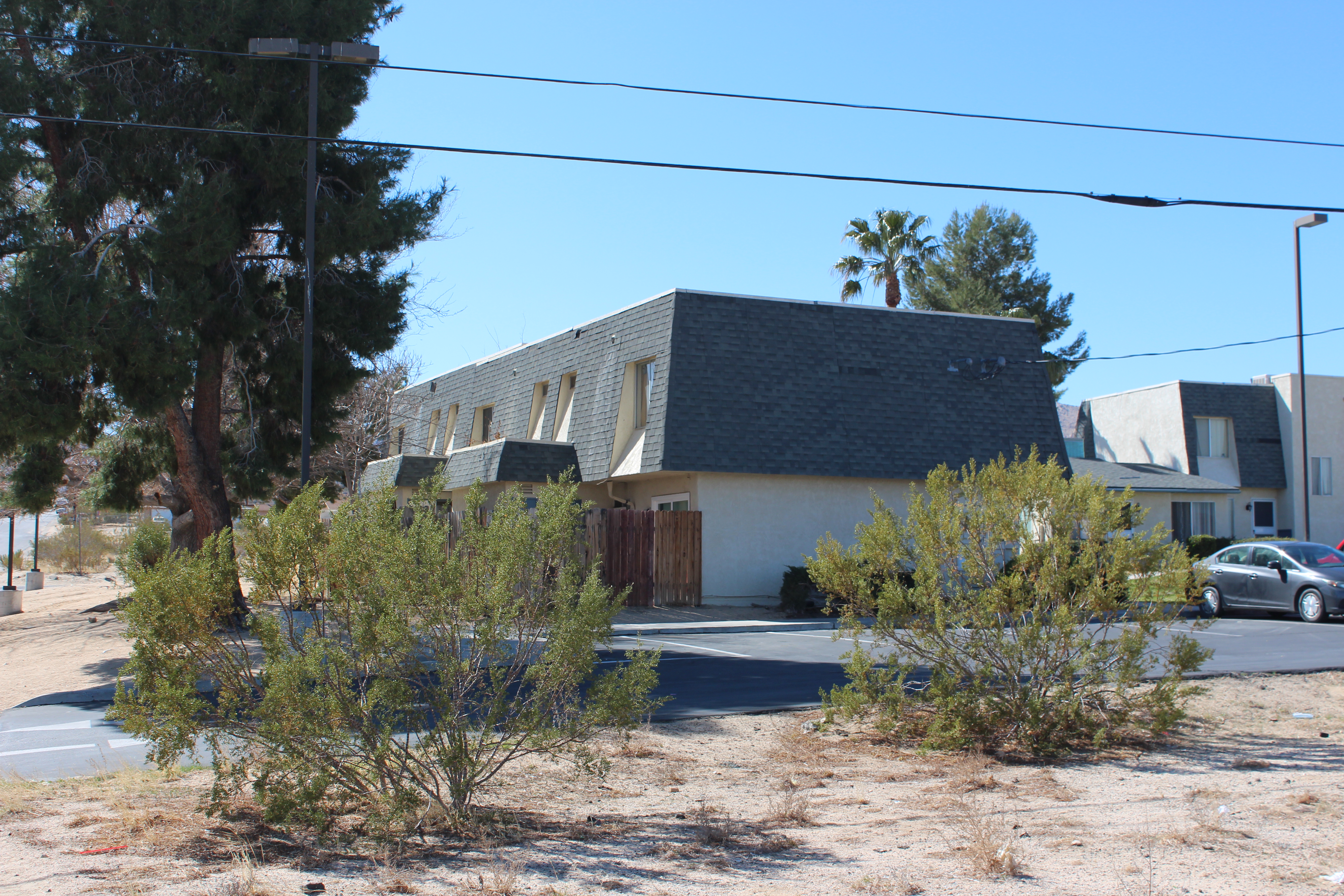 '70s Mansard roof apartments with creosote bushes