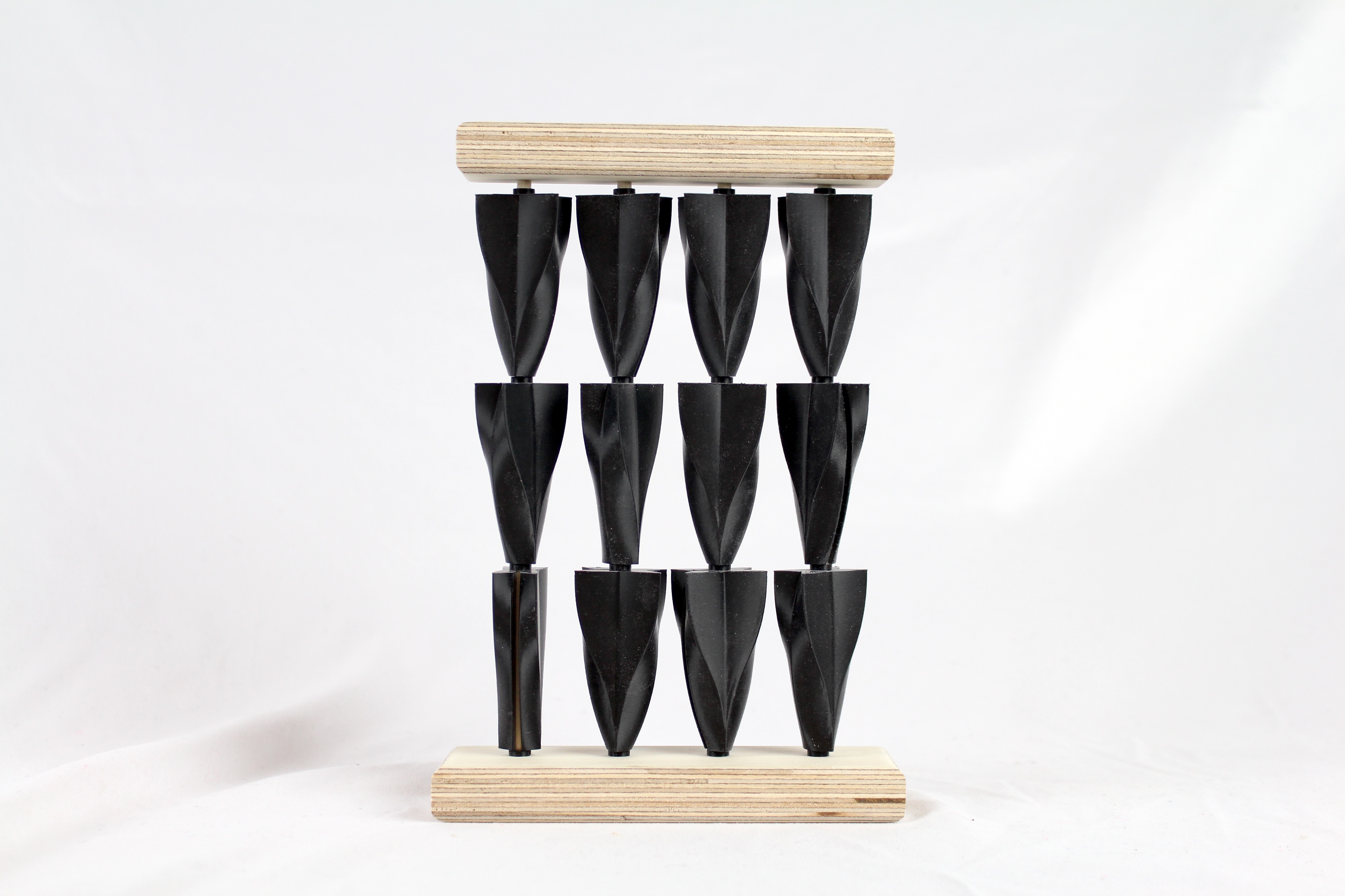 Shots of small scale 3d printed PLA and wood models showcasing the arrangements of the three different finalized shapes.