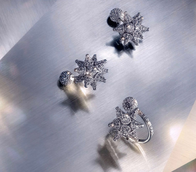KMA stylist Sara Wacksman designs set for a photo of sparkling diamond earrings with a grey shadowy background for Swarovski 