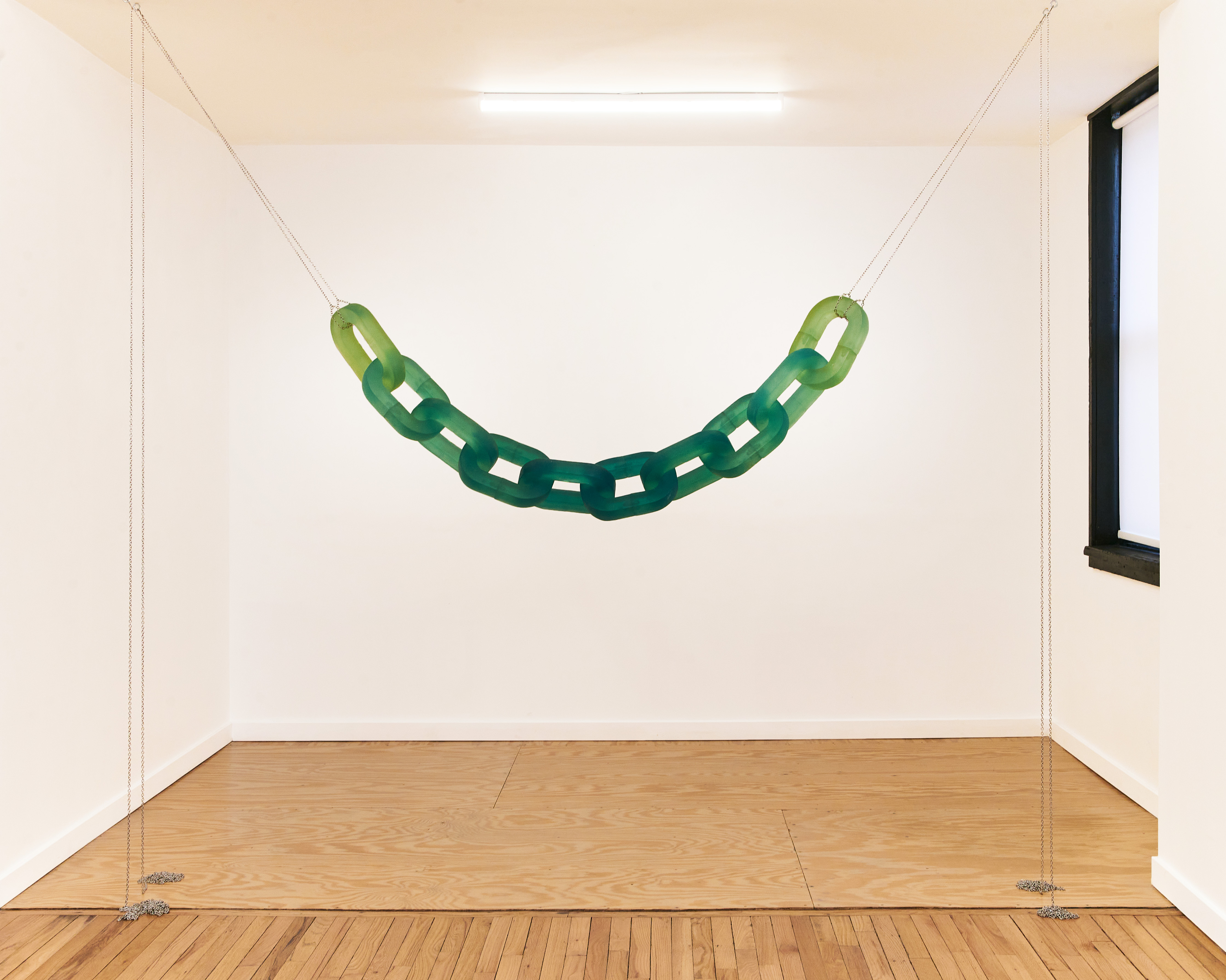 Rachel Mica Weiss, Passage, 2020, cast urethane resin, pigment, stainless steel, chain: 73 x 8 x 2 in. (185.4 x 20.3 x 5.1 cm.), overall dimensions variable. Install photo: Sean Eaton.