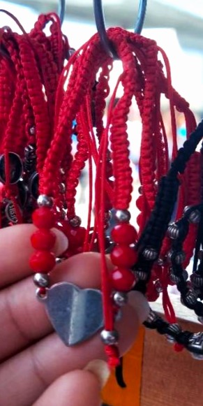 TIA CELIA and JENI wear matching red protection bracelets throughout.