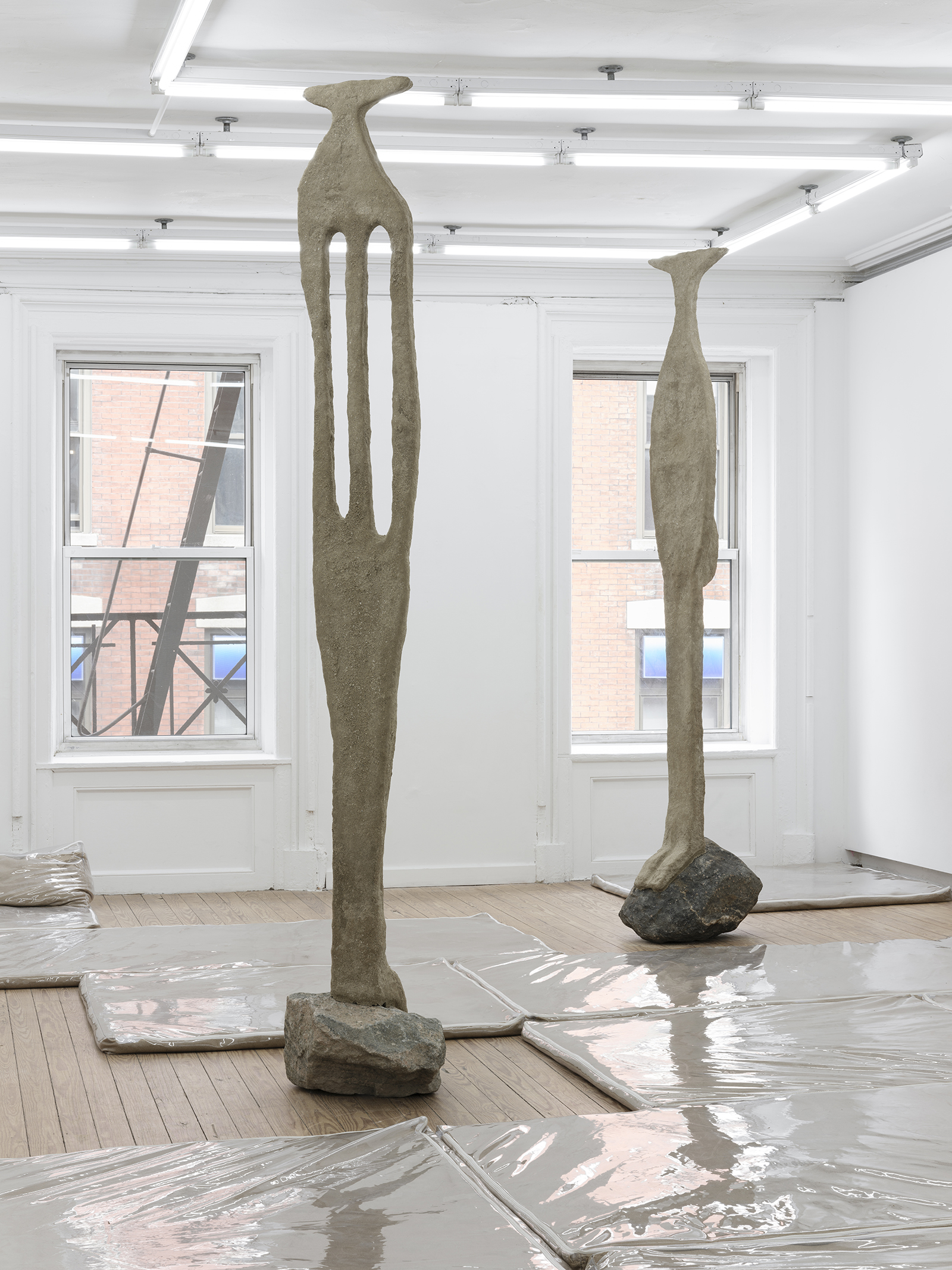 Caryatid 1 & 2, 2021, vinyl, sand, polymer, burlap, steel, rock, shower curtain hooks