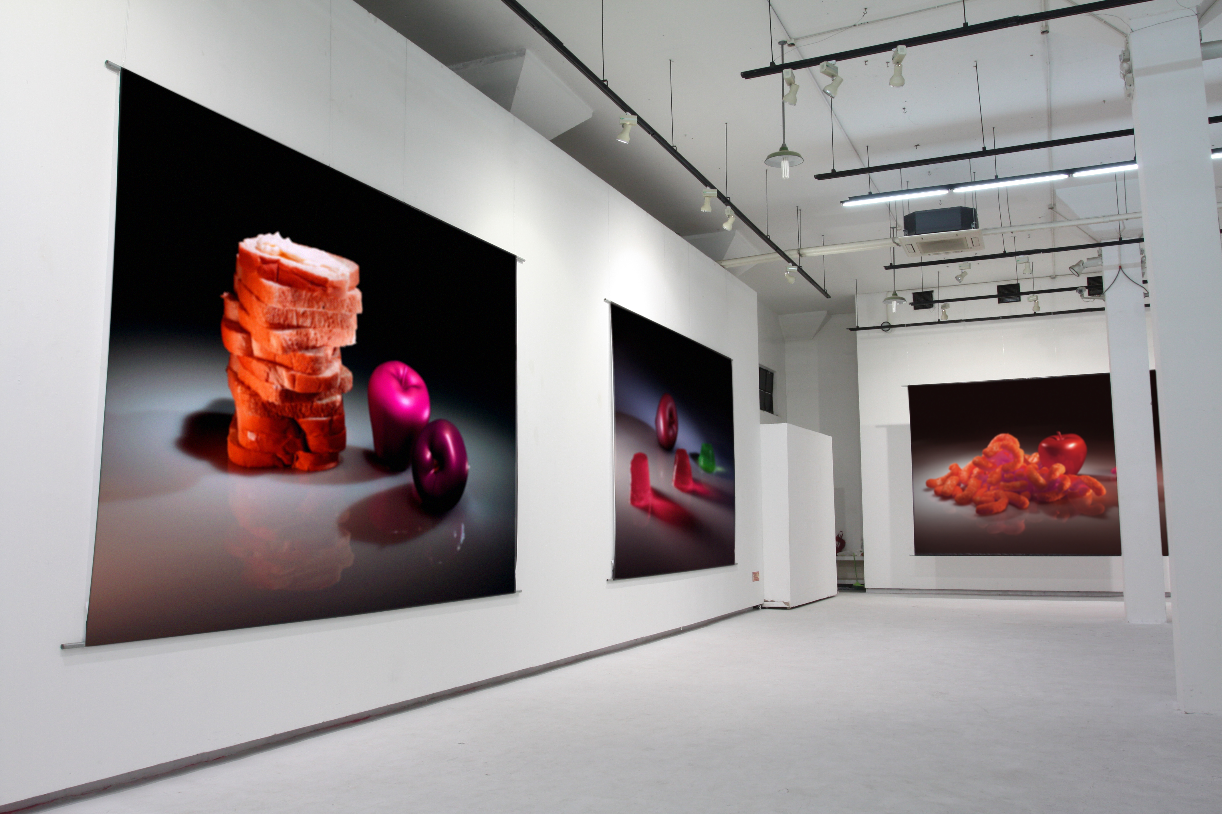 Post photographies from the series The Real and the Fake, 2011: Food for Children, RGB, and Still Life with Funyun, versions 2013, all 3 meters x 4 meters, prints on paper, hung weighted and unframed.