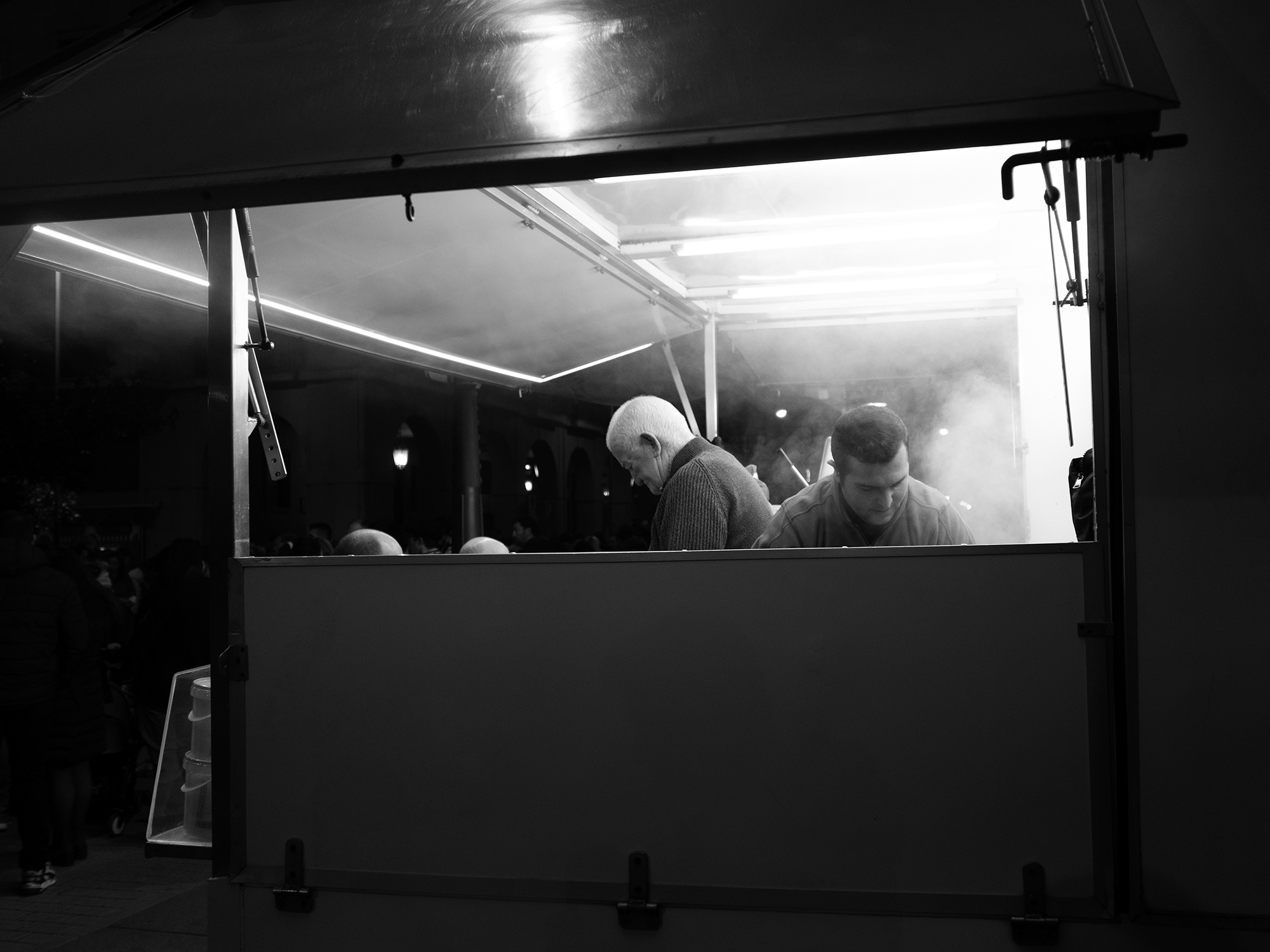 Four heads in a food truck Pamplona, Spain, 2023photography, bw, single