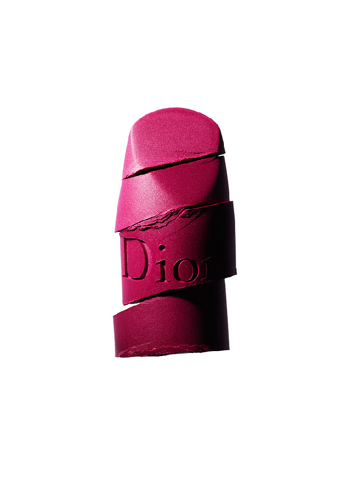 KMA stylist Rachel Haas designs set for photograph of smeared creamy hot pink lipstick against white background for Dior