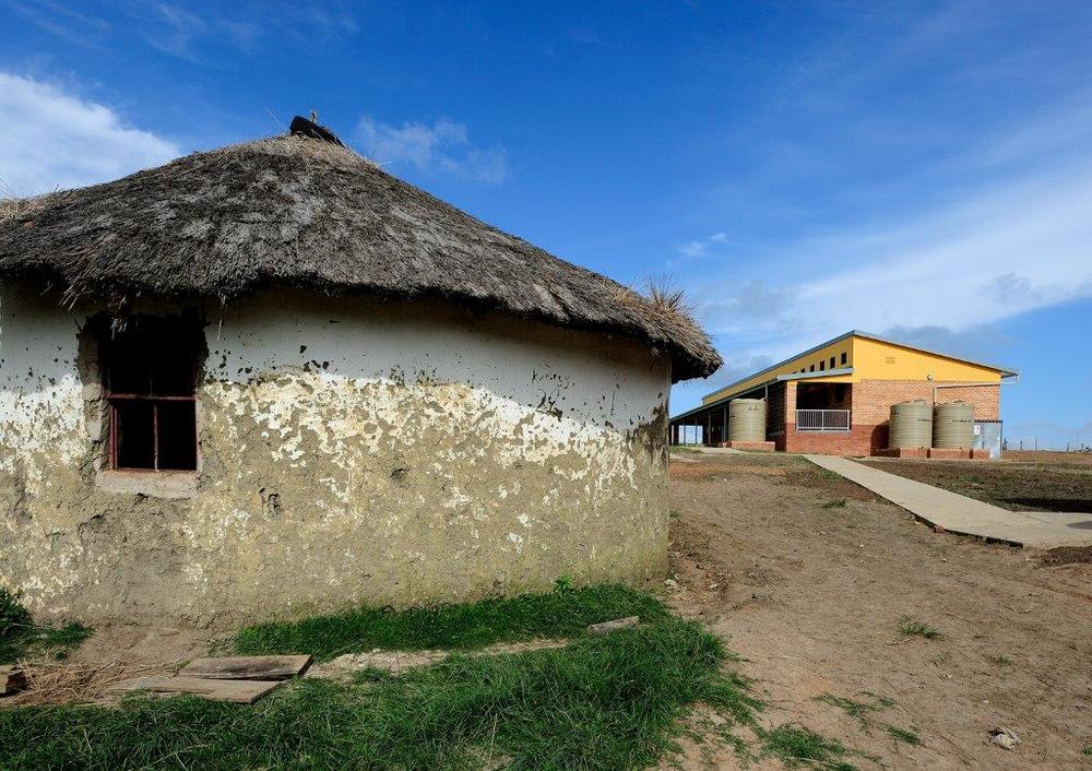 An old mud school and the newly built school in the background