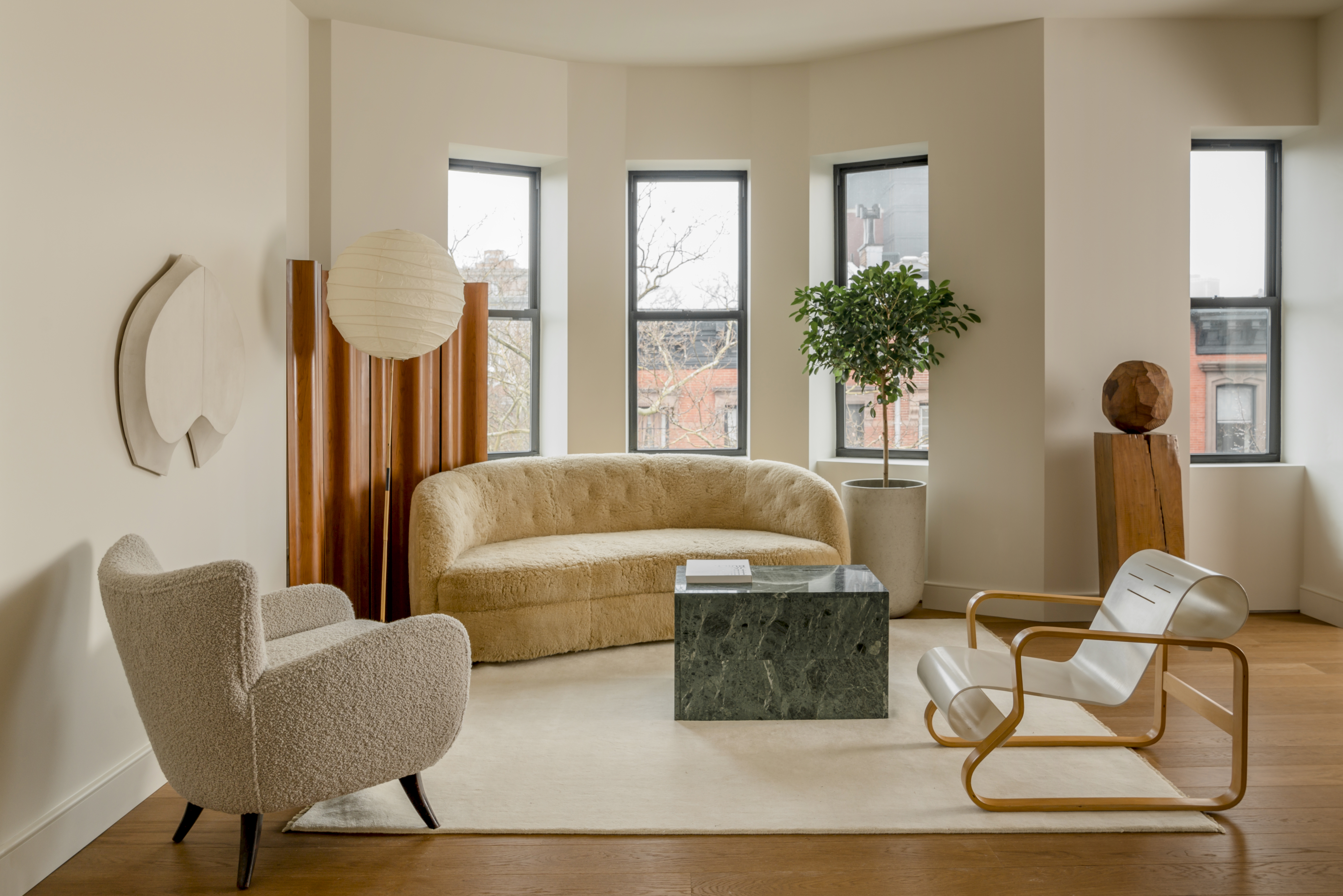 The designers saw potential centered around the building’s legacy. A dialogue of opposites was the main theme behind the creation; minimal but warm, understated yet rich. This idea was materialized through the pairing of an aluminum-clad kitchen against a traditional rounded arch, and hand-made ceramic tiles against soft contemporary lighting. A warm color palette was deployed to unify the spaces by way of gentle oak floors, cream-hued walls that contrasted with dark stone, and stained wood inset bookshelves.