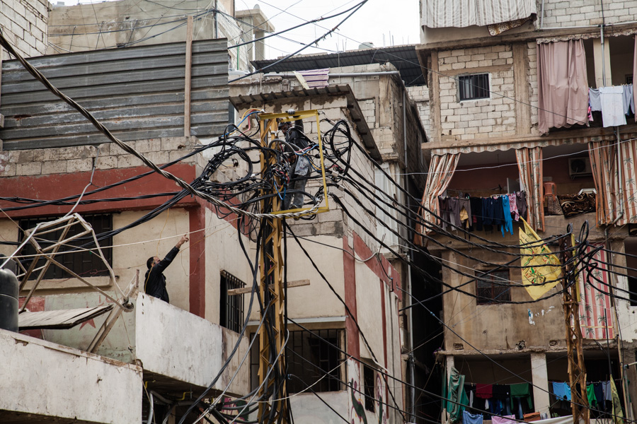  Shatila refugee camp, beirut, lebanon R&eacute;paration sur le r&eacute;seau &eacute;lectrique. Les coupures &eacute;lectriques durent plusieurs heures par jour. Les plus ais&eacute;s ach&egrave;tent un g&eacute;n&eacute;rateur ou payent pour pirater une ligne de courant. les autres sont contraints de vivre dans le noir et doivent s'adapter pour utiliser les appareils &eacute;lectriques.