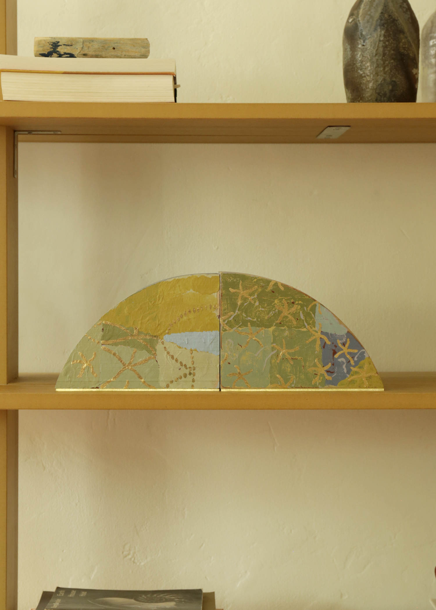 Bookends, house paint on wood with gold / silver leaf and brass base