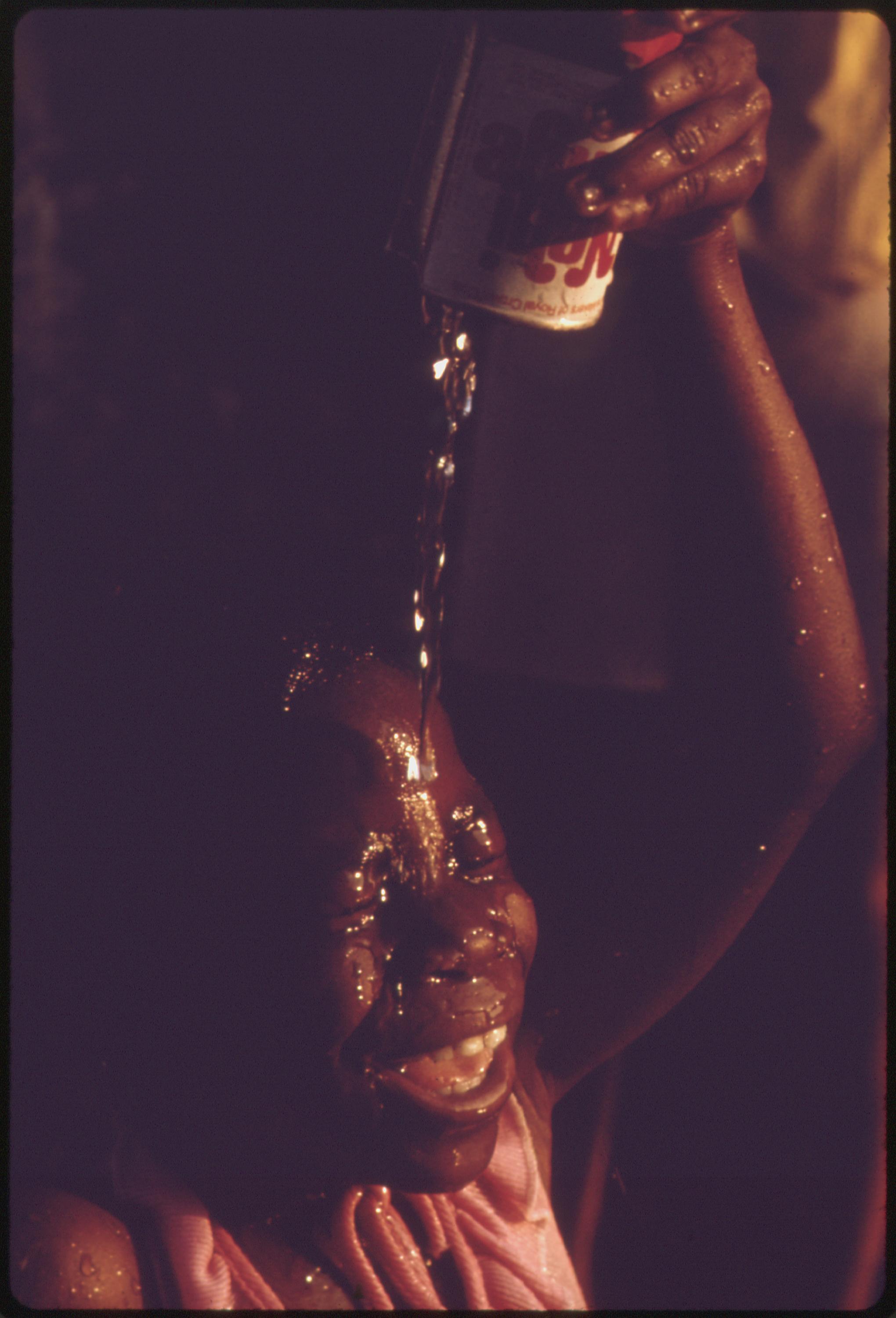 Summer fun means cooling off with water from a fire hydrant at Woodlawn community, a low income high-rise apartment complex on Chicago’s South Side. These children don’t go to the city beaches. Cooling off with open fire hydrants is a community tradition. The area has high crime and fire records. From 1960 to 1970 the percentage of Chicago Blacks with an income of $7,000 or more jumped from 26 to 56 percent, but still fell behind the gain made by whites, June 1973.