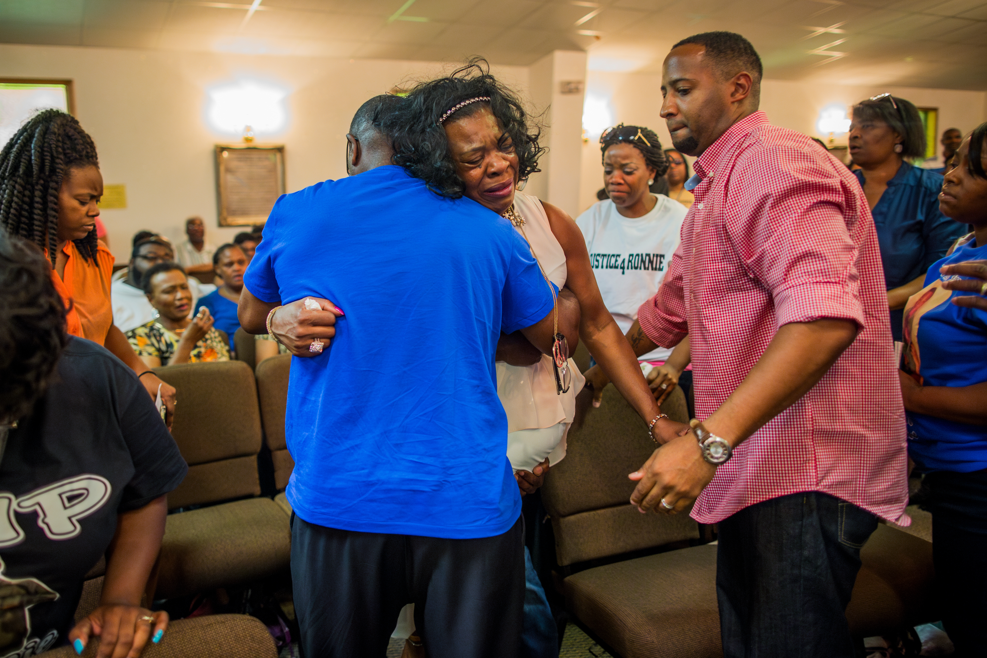 Dollie Jones is consoled at a community meeting and memorial in Tupelo, Miss. Jones’s son, Antwun Shumpert, was shot and killed by a police after running from the traffic stop. (The New York Times)