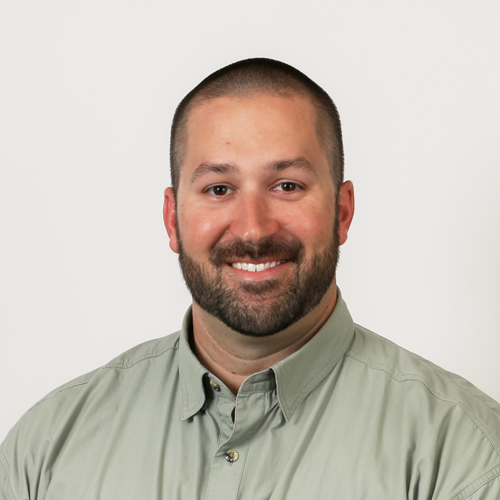 Headshot of Adam Lytch. He is wearing an olive colored button down shirt.